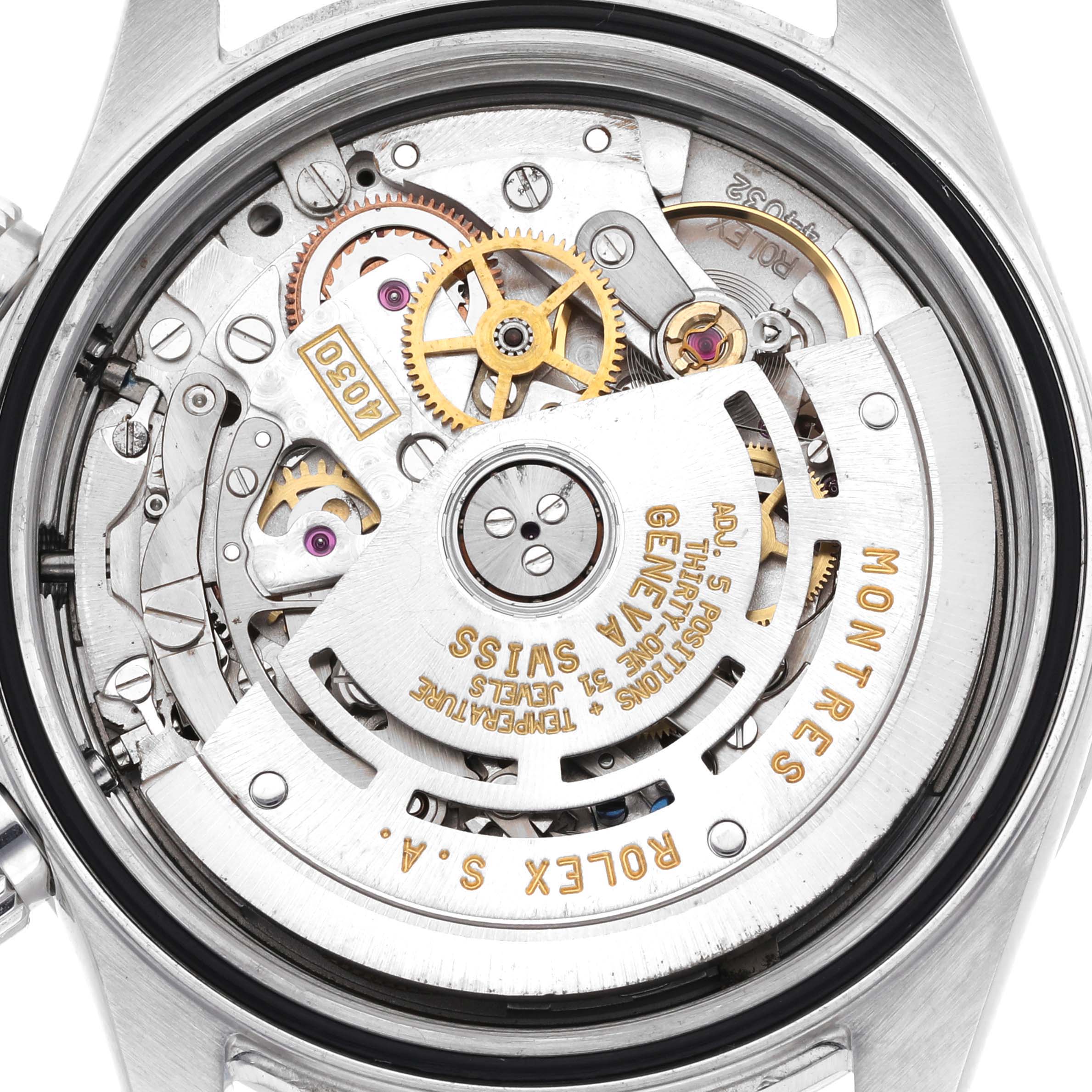 The image shows the inner mechanism of a Rolex Daytona 16520 Men's Stainless Steel Black Dial watch, featuring gears and the rotor from the back.