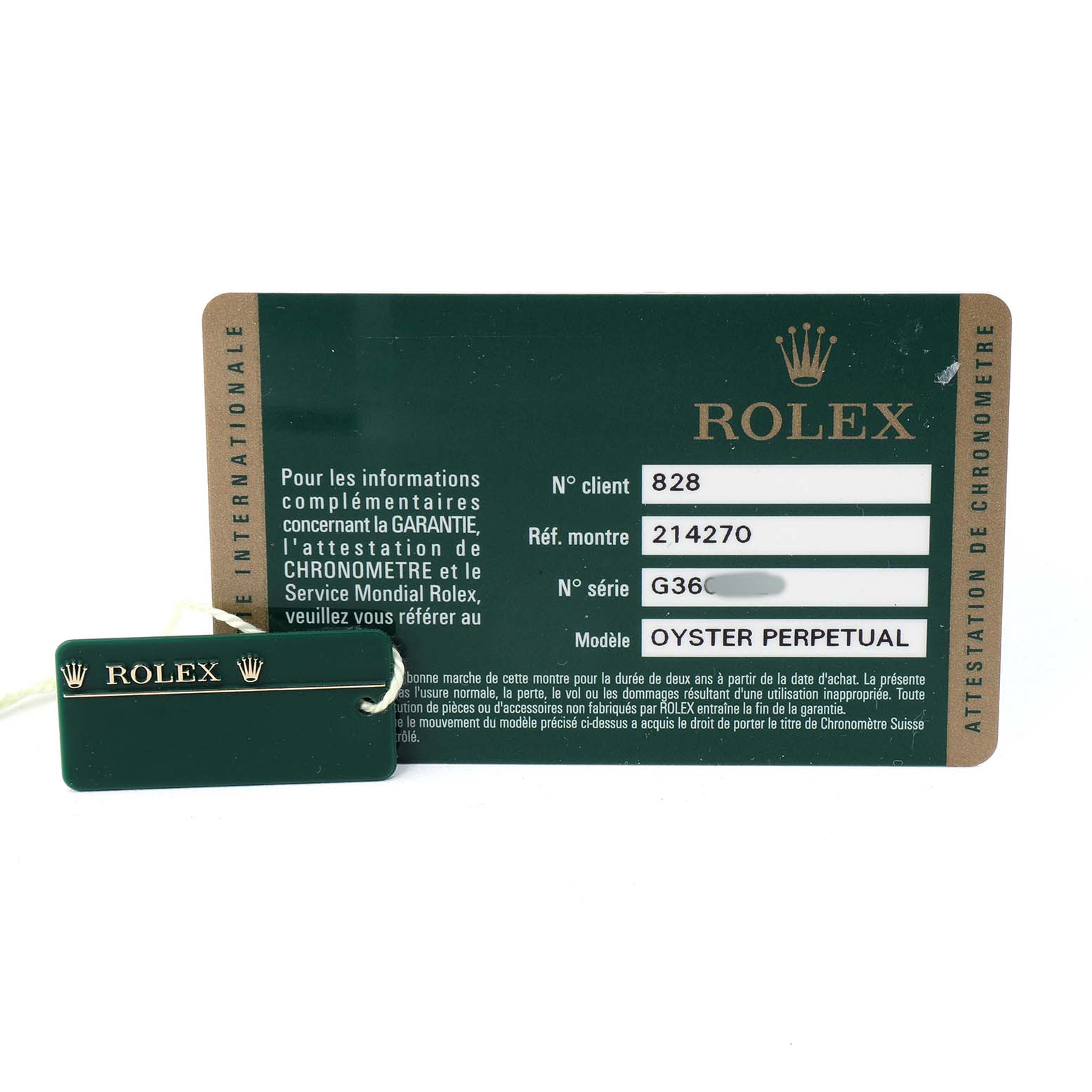 The image shows a Rolex Explorer 214270 Men's Stainless Steel Black Dial card and a green tag, displaying model and serial numbers.