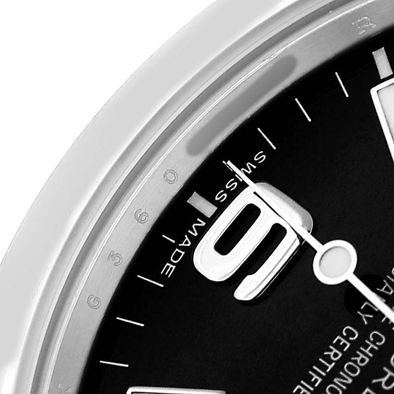 The image shows a close-up of a Rolex Explorer 214270 Men's Stainless Steel Black Dial watch dial, highlighting the minute markings and "Swiss Made" text.