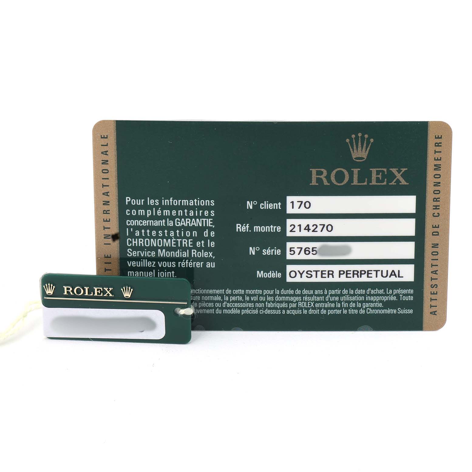 The image shows a Rolex Explorer 214270 Men's Stainless Steel Black Dial model warranty card and a green Rolex tag, displaying model details.