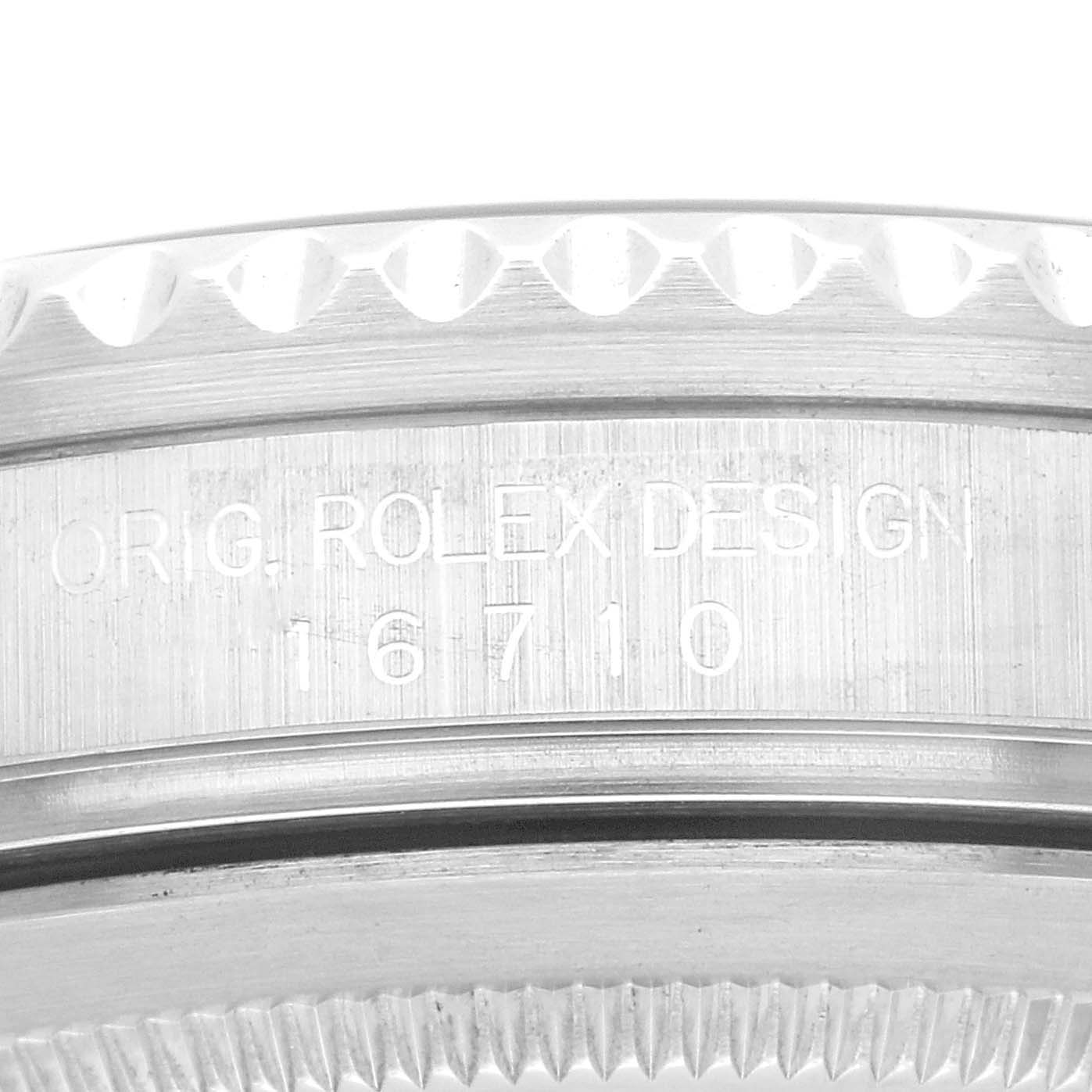 Close-up view of the side of a Rolex GMT-Master 16710 Men's Stainless Steel Black Dial 16710 Men's Stainless Steel Black Dial watch highlighting the case with engraving “ORIG. ROLEX DESIGN 16710”.