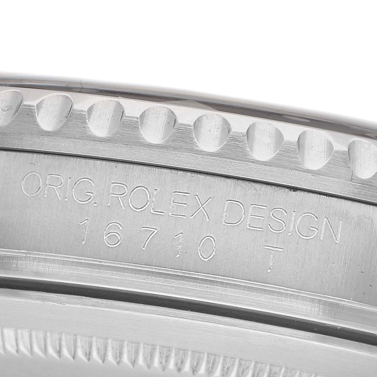 The image shows a close-up of the engraved side of the Rolex GMT-Master 16710 Men's Stainless Steel Black Dial model, focusing on the case details.