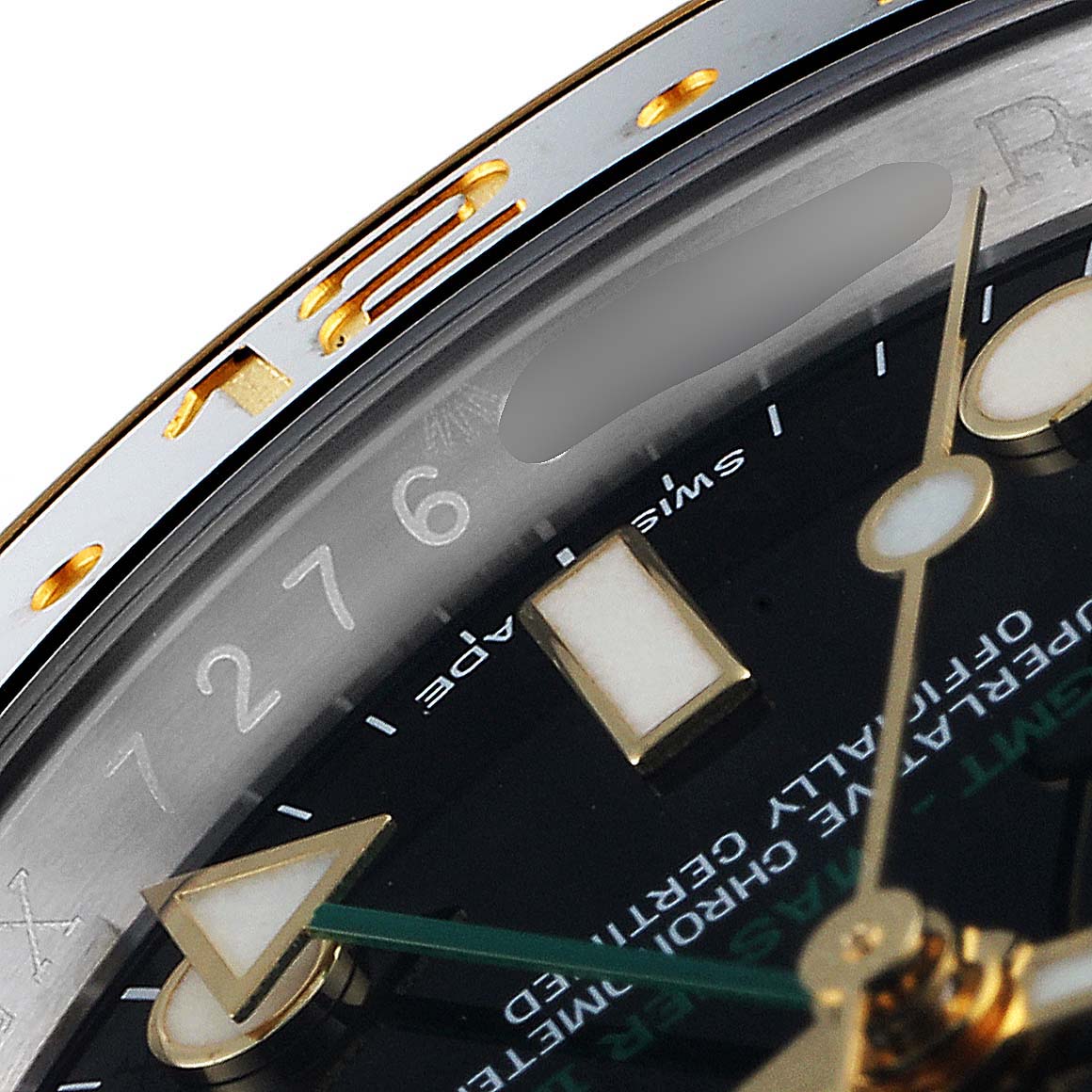 Close-up of the Rolex GMT-Master 116713 Men
s Steel and Gold (two tone) Black Dial 116713 Men
s Steel and Gold (two tone) Black Dial watch showing part of the dial, numbers, and bezel edges.