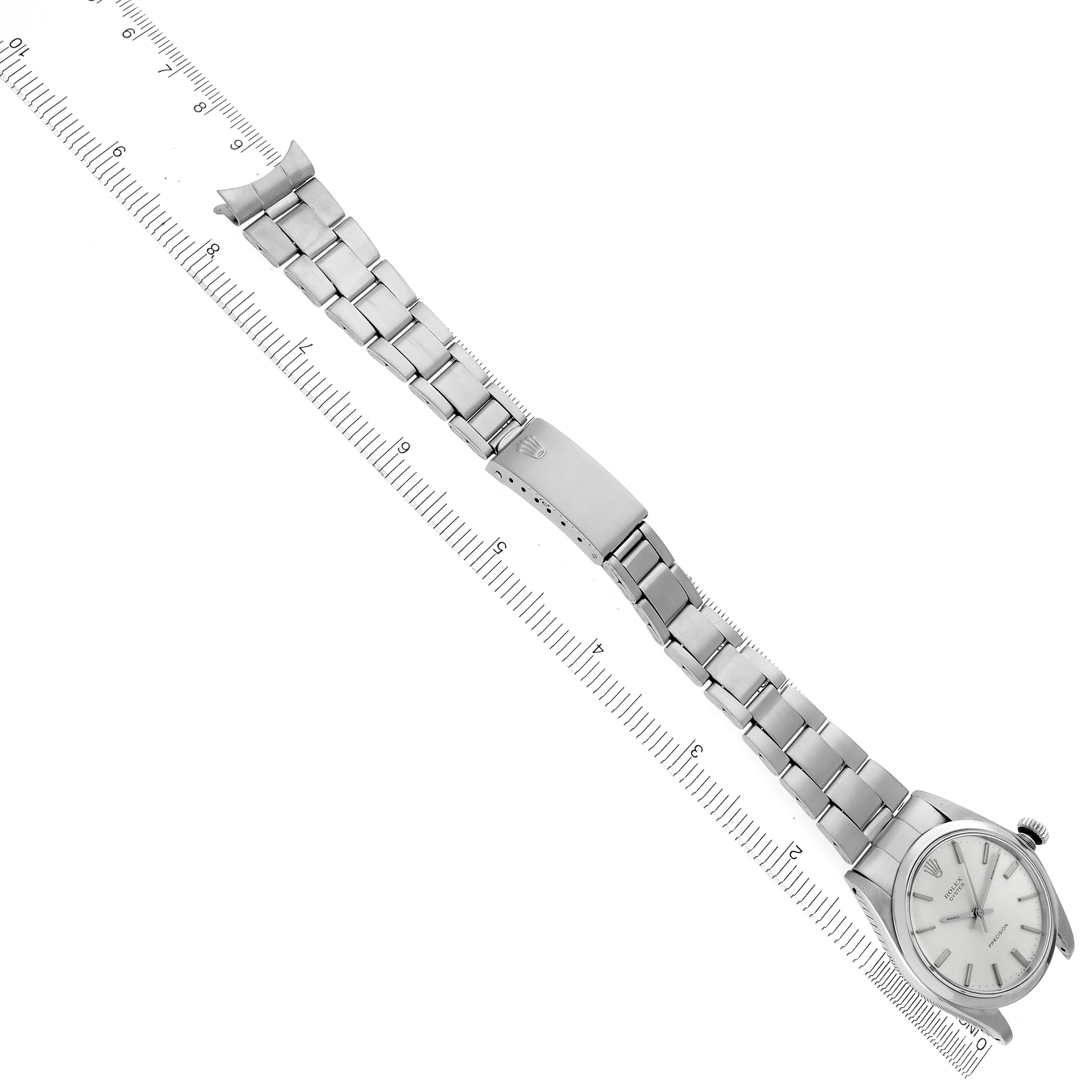 The Rolex Vintage Collection 6426 Men's Stainless Steel Silver Dial 6426 Men's Stainless Steel Silver Dial watch is shown from a top-down angle, displaying its entire bracelet and clasp on a measuring ruler.