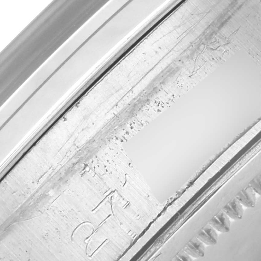 This image shows a close-up of the engraved case back edge of a Rolex Date 6694 Men's Stainless Steel Silver Dial 6694 Men's Stainless Steel Silver Dial model watch.
