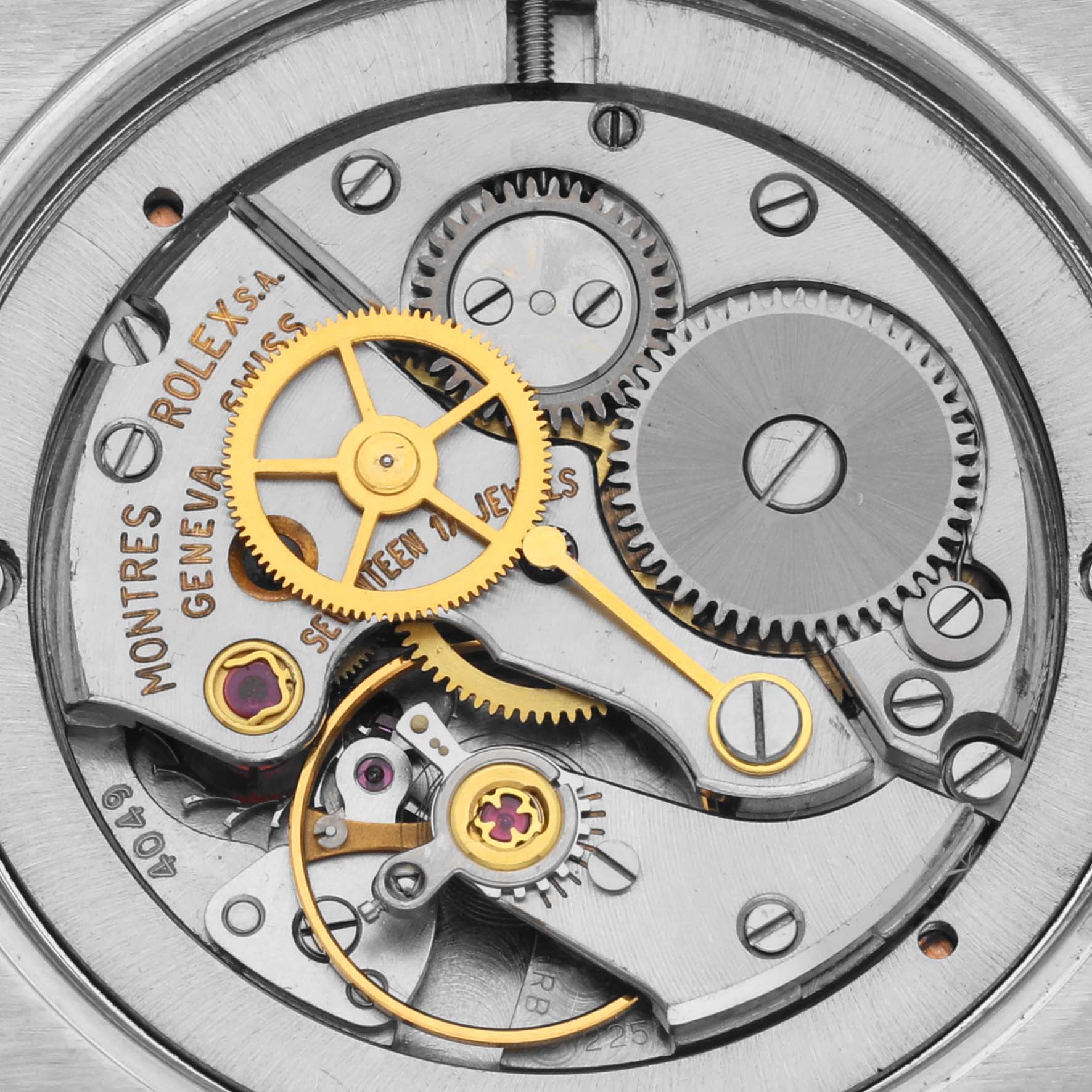 The image shows the internal mechanism of a Rolex Date 6694 Men's Stainless Steel Silver Dial 6694 Men's Stainless Steel Silver Dial watch, highlighting gears and jewels from a top-down perspective.