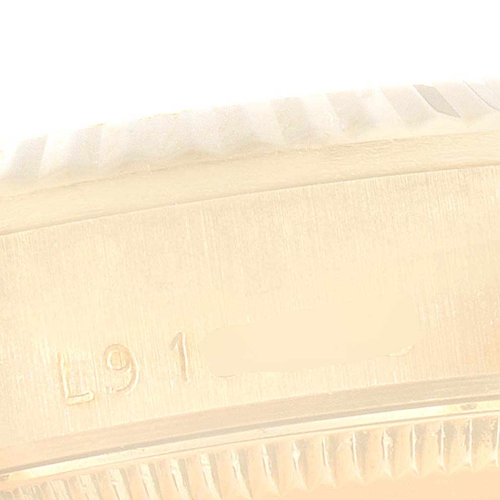 This close-up image shows part of the case and serial engraving on a Rolex President 68278 Women's Yellow Gold Champagne Dial 68278 Women's Yellow Gold Champagne Dial model.