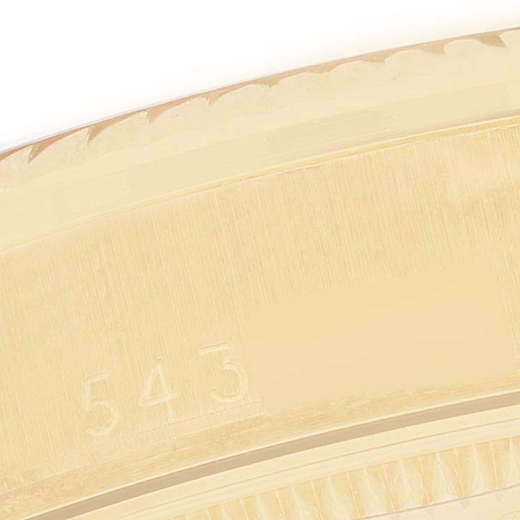 The image shows a close-up of the engraving on the bezel of a Rolex President 6827 Women's Yellow Gold Silver Dial model watch.