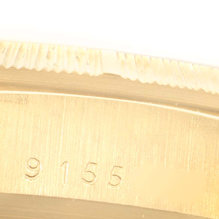 The image shows a close-up of the bezel and part of the case of a Rolex President 18078 Men's Yellow Gold Black Dial 18078 Men's Yellow Gold Black Dial watch, including engraved numbers.