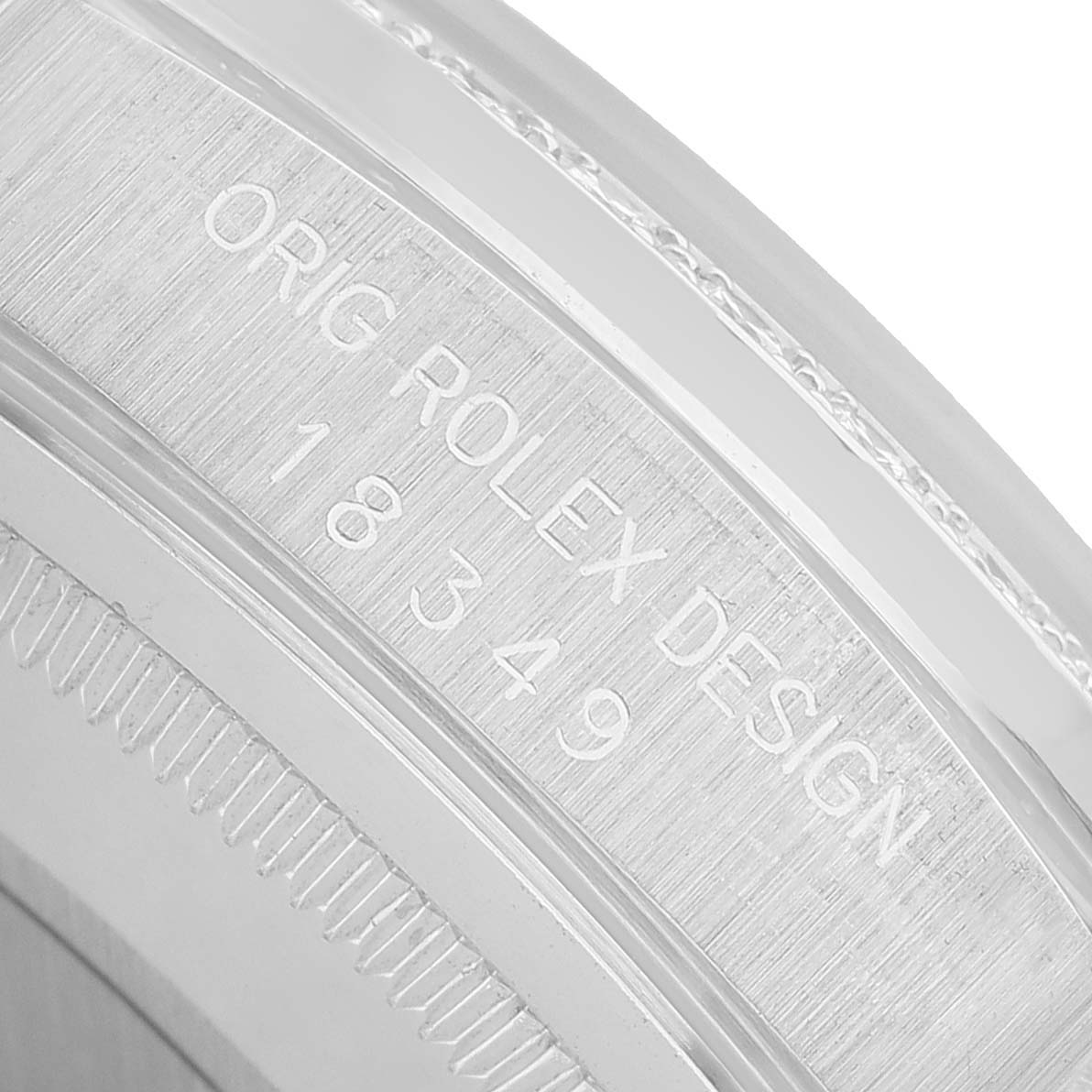 The image shows a close-up of the engraved edge of the Rolex President 18349 Men's White Gold Silver Dial model, displaying the design and model number.