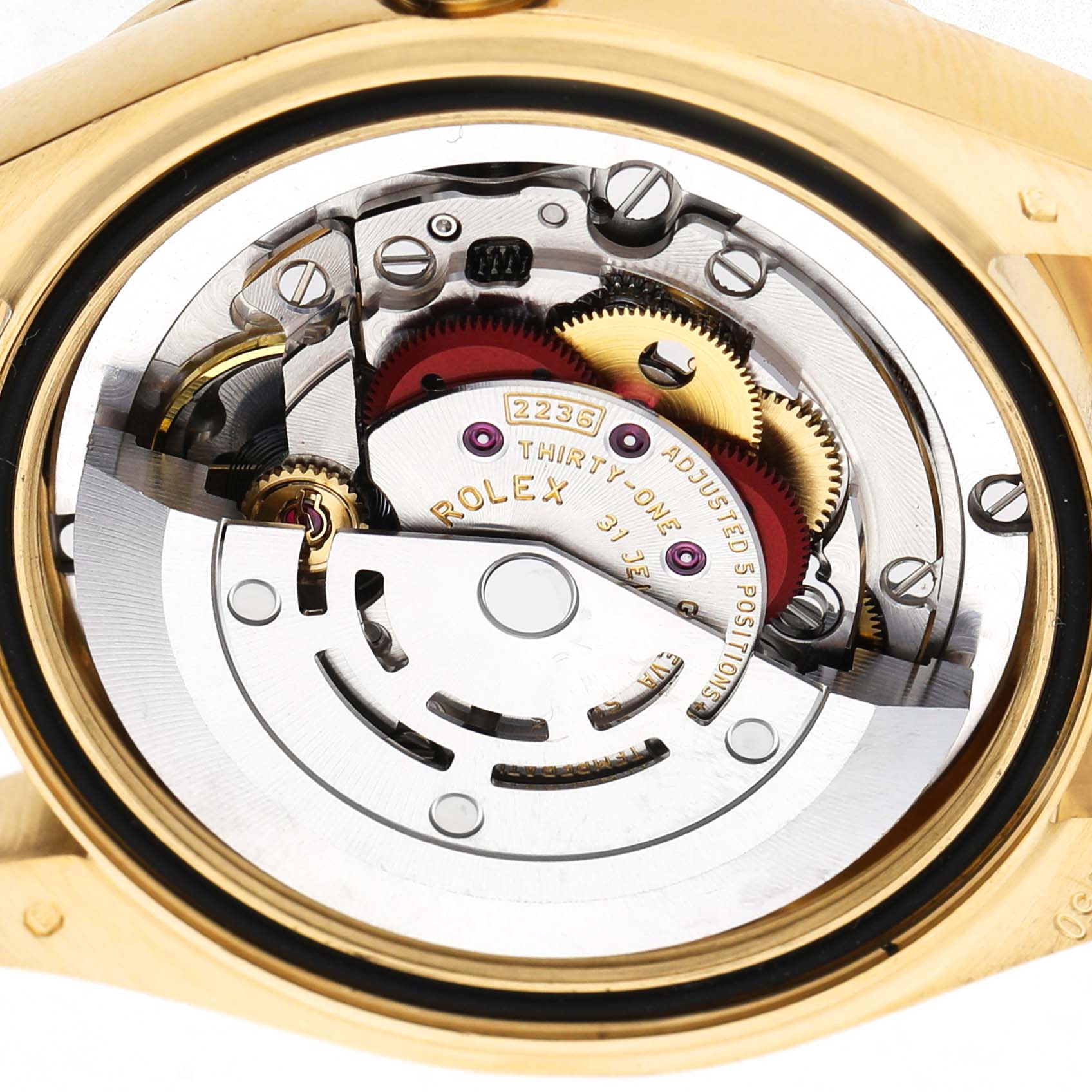 The image shows the inner mechanism of a Rolex President 278288 Women's Yellow Gold Mother of Pearl Dial watch from the back, highlighting gears and inscriptions.