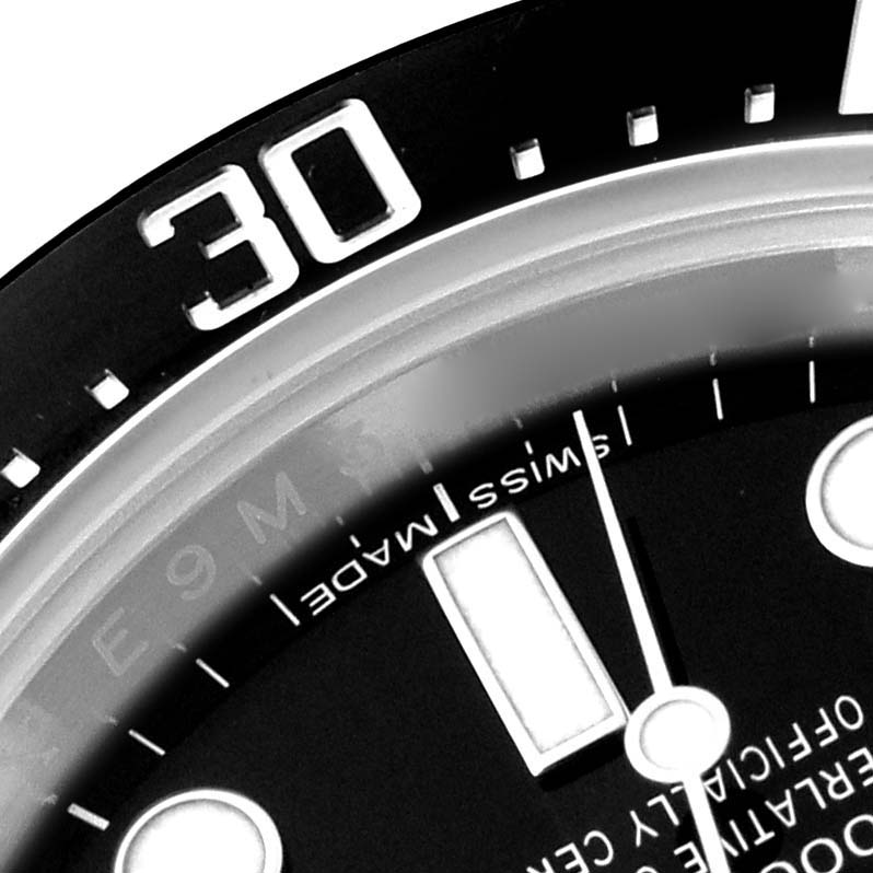 The image shows a close-up of the bezel and part of the dial of a Rolex Sea-Dweller 116600 Men's Stainless Steel Black Dial 116600 Men's Stainless Steel Black Dial watch.