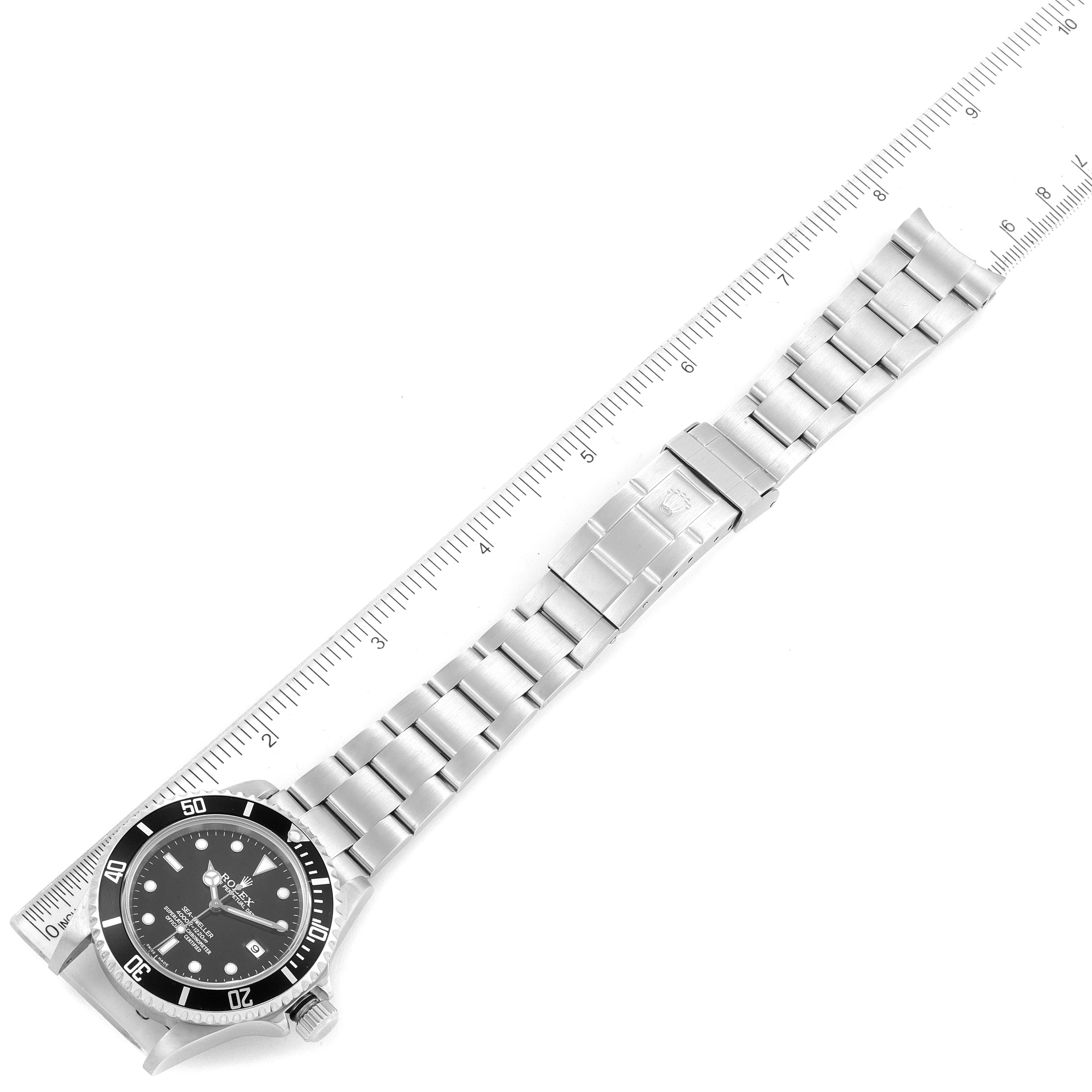 The image shows a top-down view of a Rolex Sea-Dweller 16600 Men
s Stainless Steel Black Dial 16600 Men
s Stainless Steel Black Dial watch with a ruler beside it for scale.