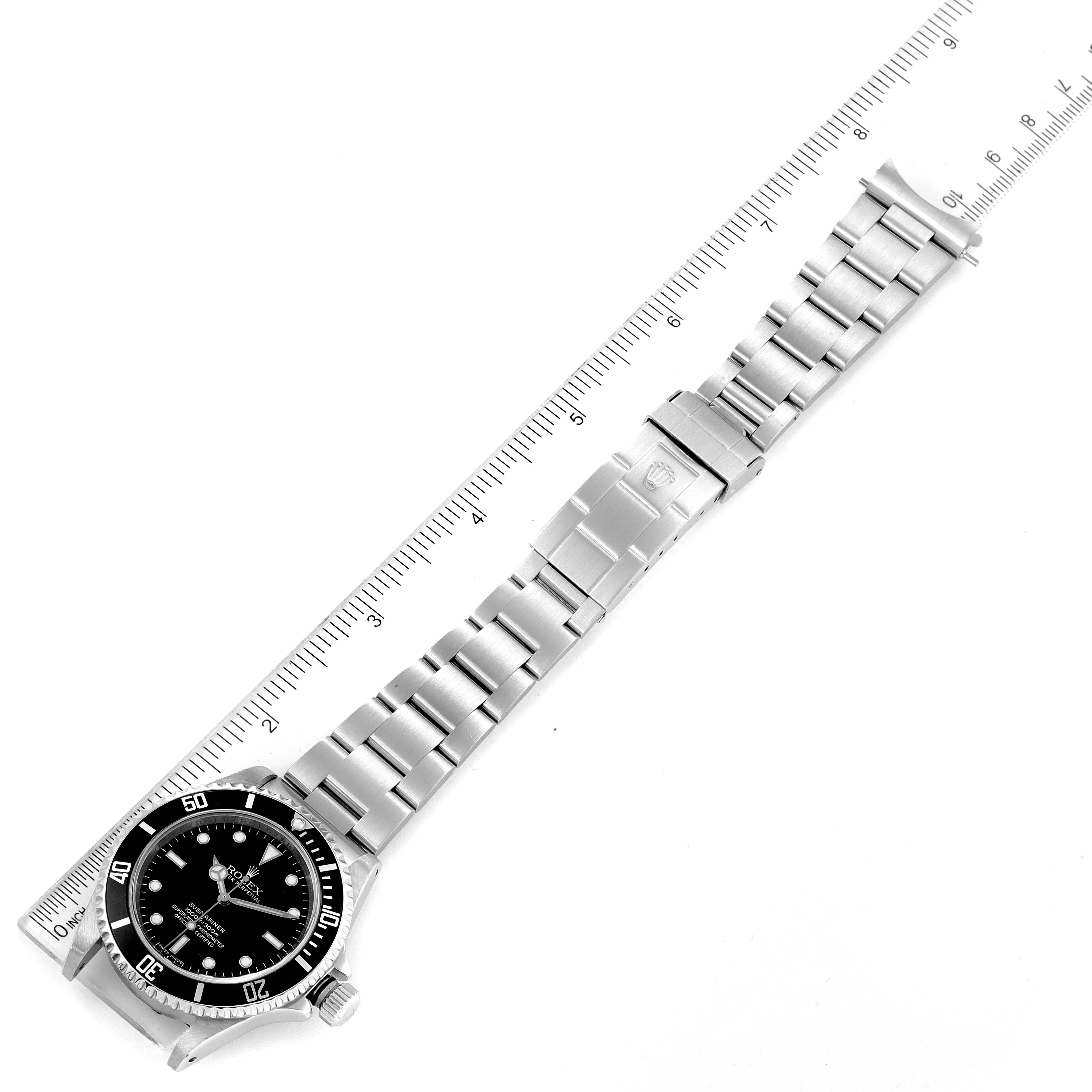 The image shows the full length and front view of a Rolex Submariner 14060M Men
s Stainless Steel Black Dial 14060M Men
s Stainless Steel Black Dial watch, with a ruler beside it for size reference.