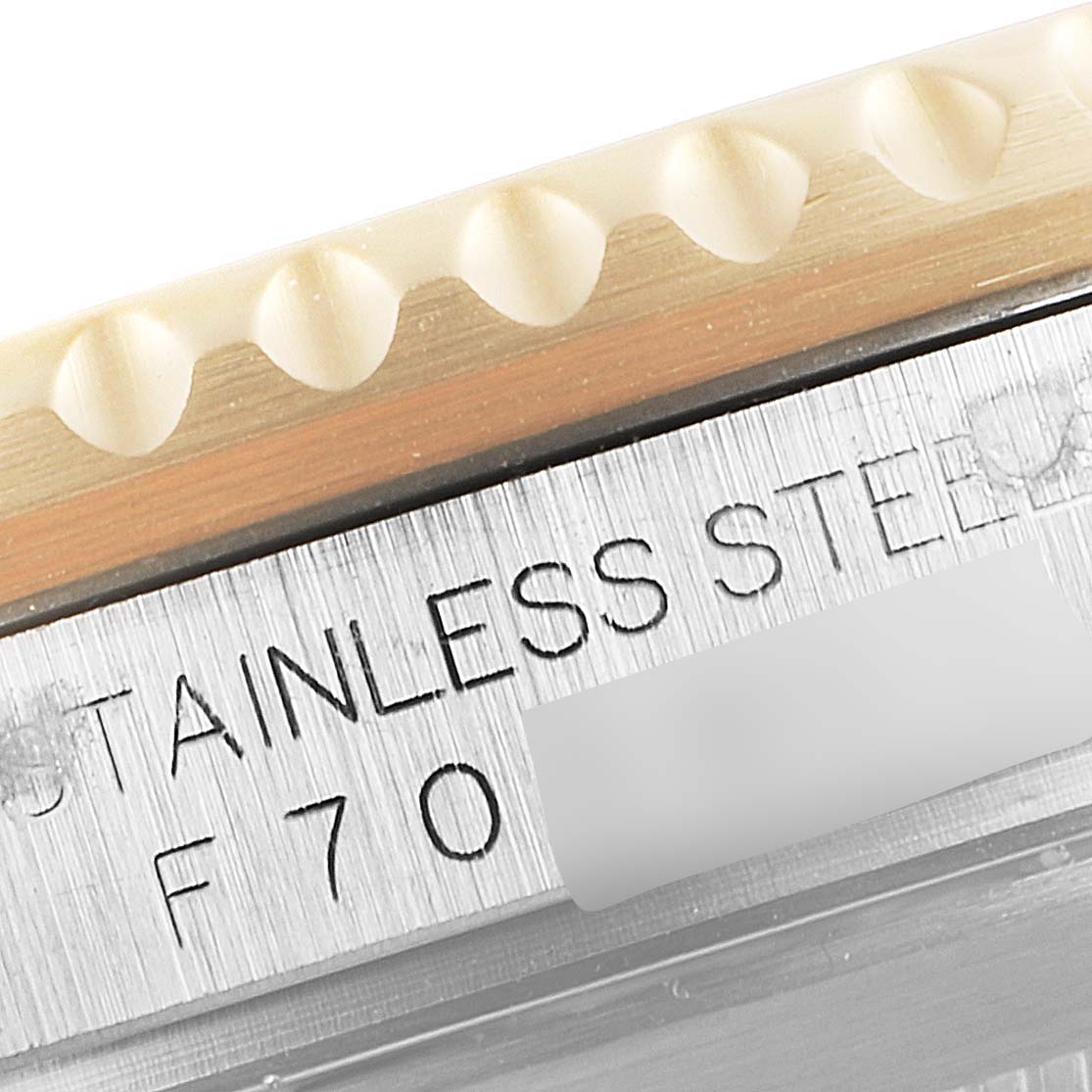 This close-up angle of the Rolex Submariner 16613 Men's Steel and Gold (two tone) Blue Dial 16613 Men's Steel and Gold (two tone) Blue Dial shows part of the bezel and the stainless steel engraved section.