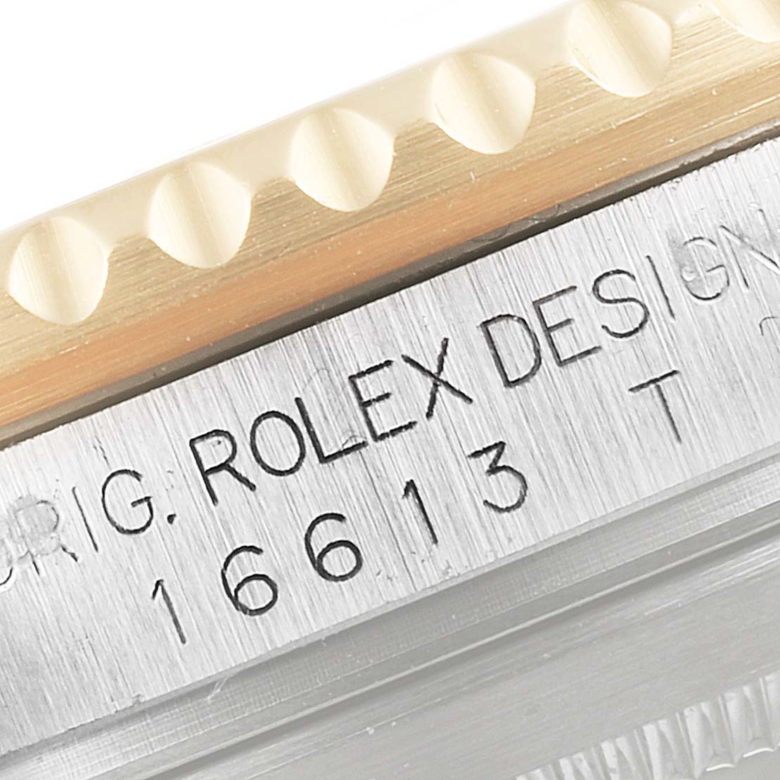 This image shows a close-up of the model and branding engravings on the case side of a Rolex Submariner 16613 Men's Steel and Gold (two tone) Blue Dial 16613 Men's Steel and Gold (two tone) Blue Dial watch.