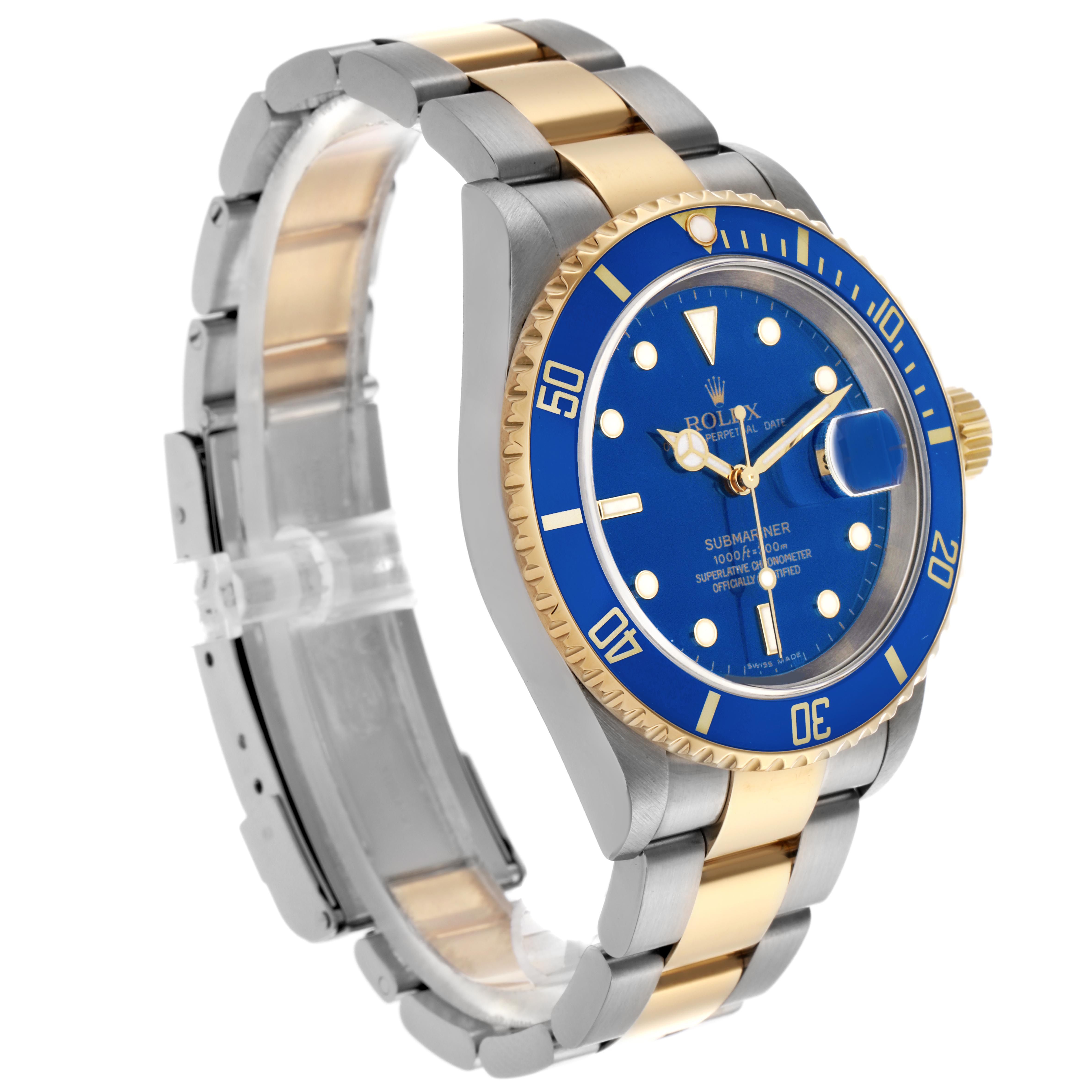 The Rolex Submariner 16613 Men's Steel and Gold (two tone) Blue Dial 16613 Men's Steel and Gold (two tone) Blue Dial is shown at a three-quarter angle, highlighting its blue dial, bezel, and two-tone bracelet.