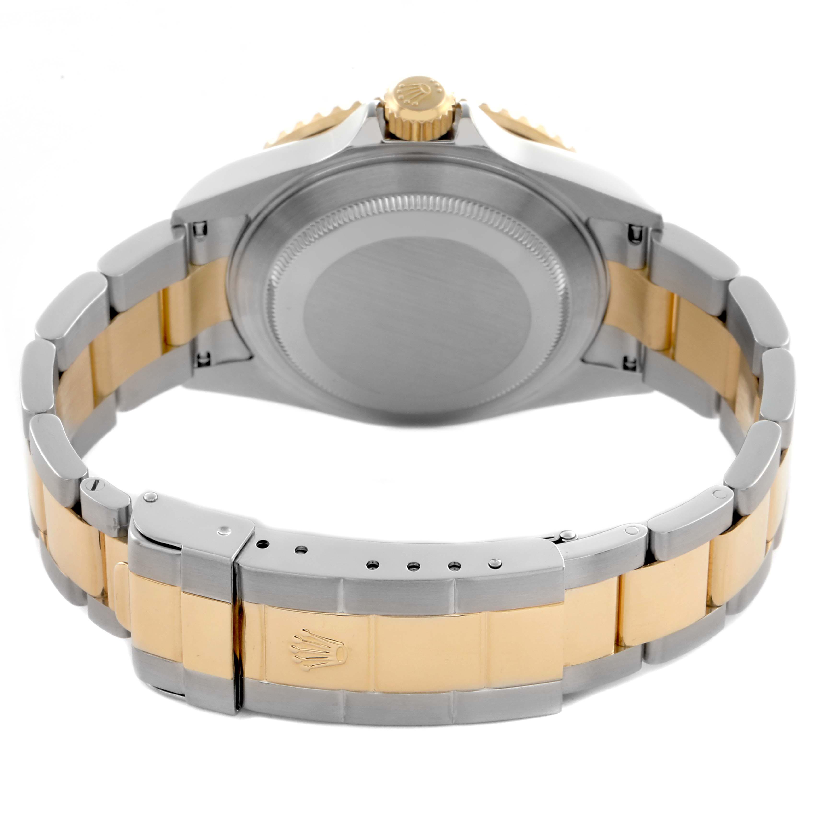 The image shows the back view of a Rolex Submariner 16613 Men's Steel and Gold (two tone) Blue Dial 16613 Men's Steel and Gold (two tone) Blue Dial, highlighting the case back, crown, and two-tone bracelet.