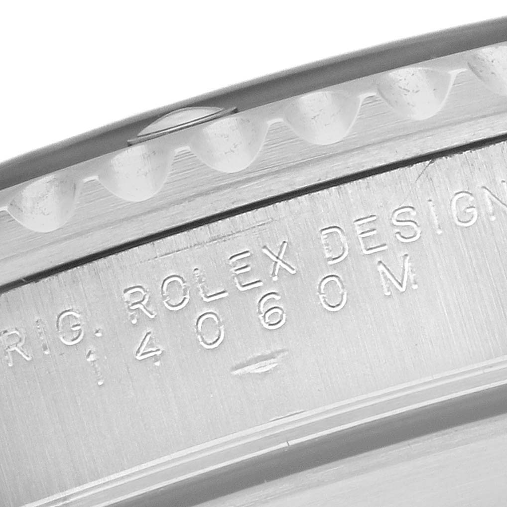 This image shows a close-up of the side of a Rolex Submariner 14060 Men
s Stainless Steel Black Dial 14060 Men
s Stainless Steel Black Dial watch case, highlighting the engravings.