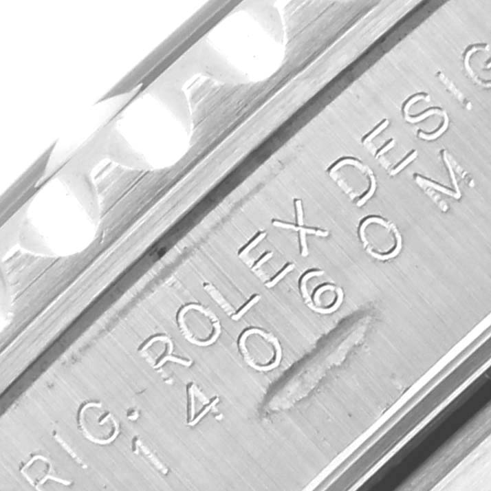 The image shows a close-up of a Rolex Submariner 14060M Men's Stainless Steel Black Dial 14060M Men's Stainless Steel Black Dial's bezel, highlighting its engraved details.