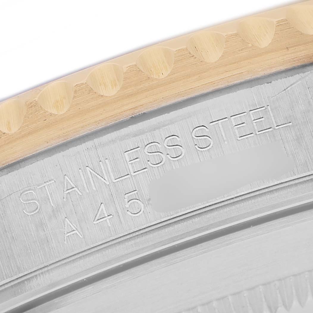 The image shows a close-up of the engraved side of a Rolex Submariner 16613 Men's Steel and Gold (two tone) Blue Dial's stainless steel case, with part of the bezel visible.