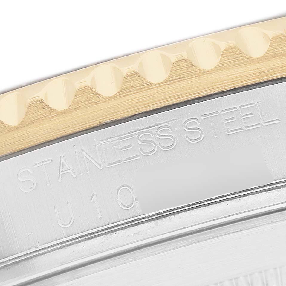 The image shows a close-up of the bezel and case edge of a Rolex Submariner 16613 Men's Steel and Gold (two tone) Silver Dial, highlighting engravings and material details.
