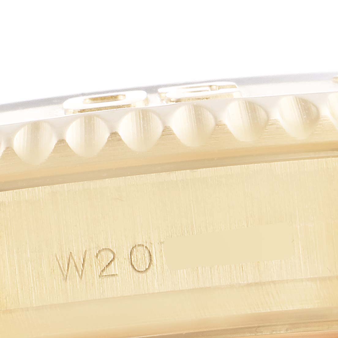 This image shows a close-up of the engraved side of the bezel and casing of a Rolex Yacht-Master 68628 Men's Yellow Gold White Dial 68628 Men's Yellow Gold White Dial watch.