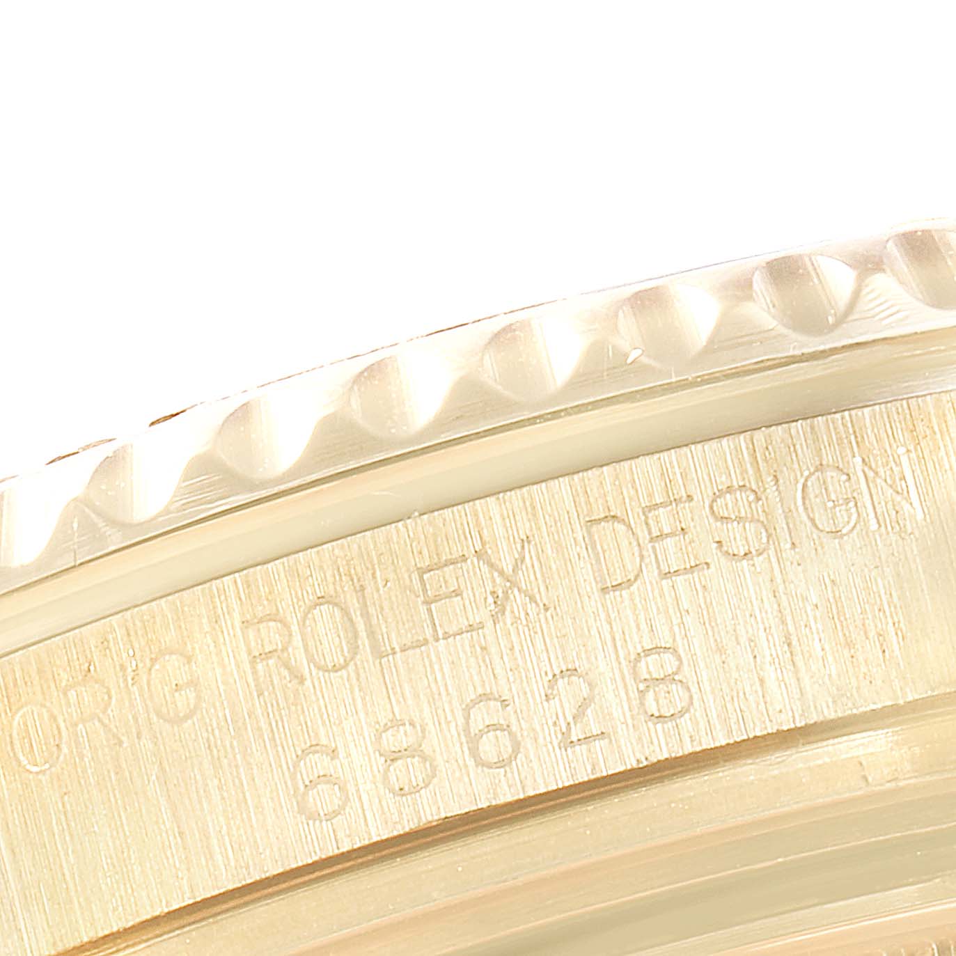 This image shows a close-up of the bezel and engraved case side of a Rolex Yacht-Master 68628 Men's Yellow Gold White Dial 68628 Men's Yellow Gold White Dial watch.