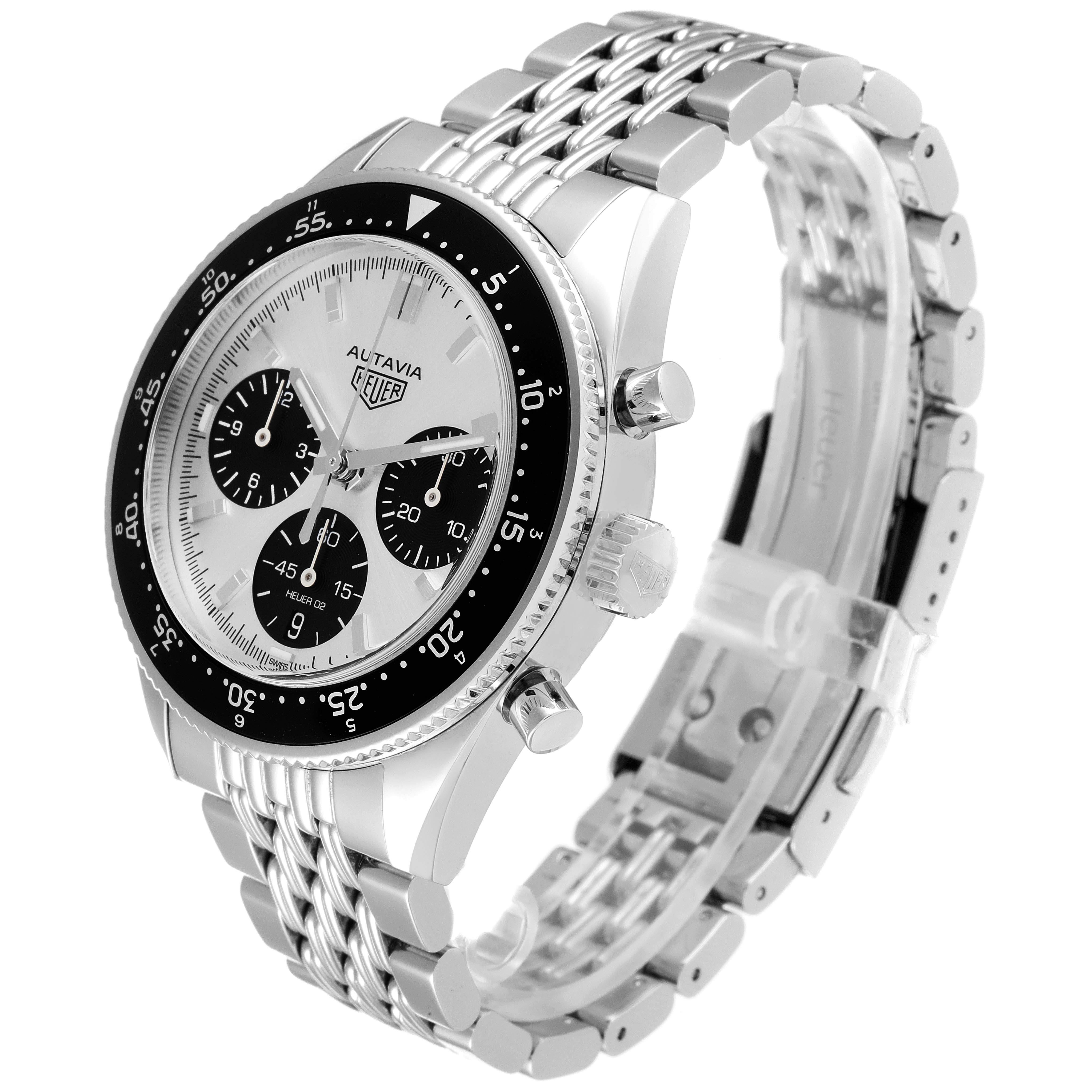 The Tag Heuer Autavia watch is shown at an angle displaying the dial, bezel, side pushers, crown, and metal bracelet.
