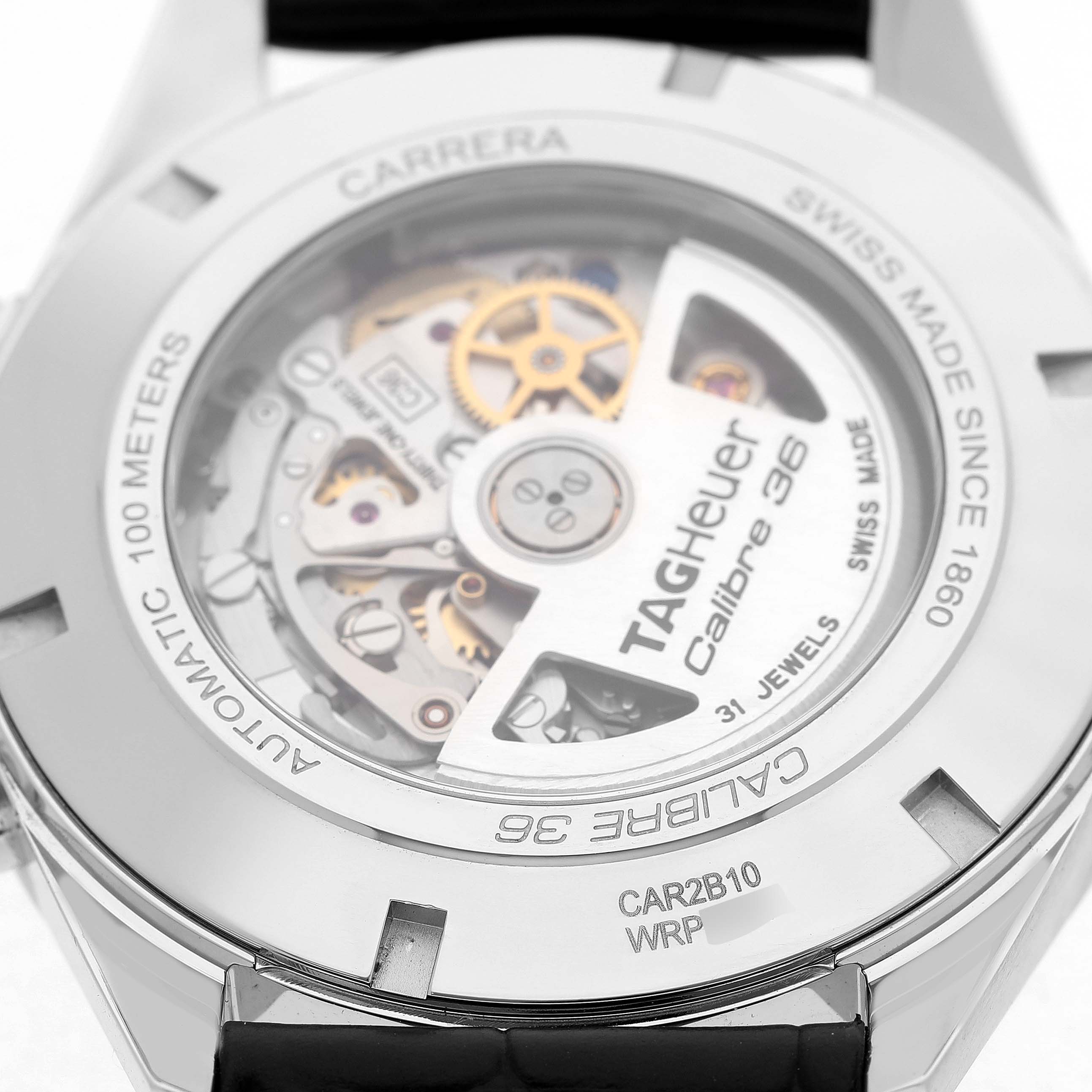 The image shows the back of a Tag Heuer Carrera CAR2B10 Men's Stainless Steel Black Dial watch, highlighting the Calibre 36 movement through a transparent case back.