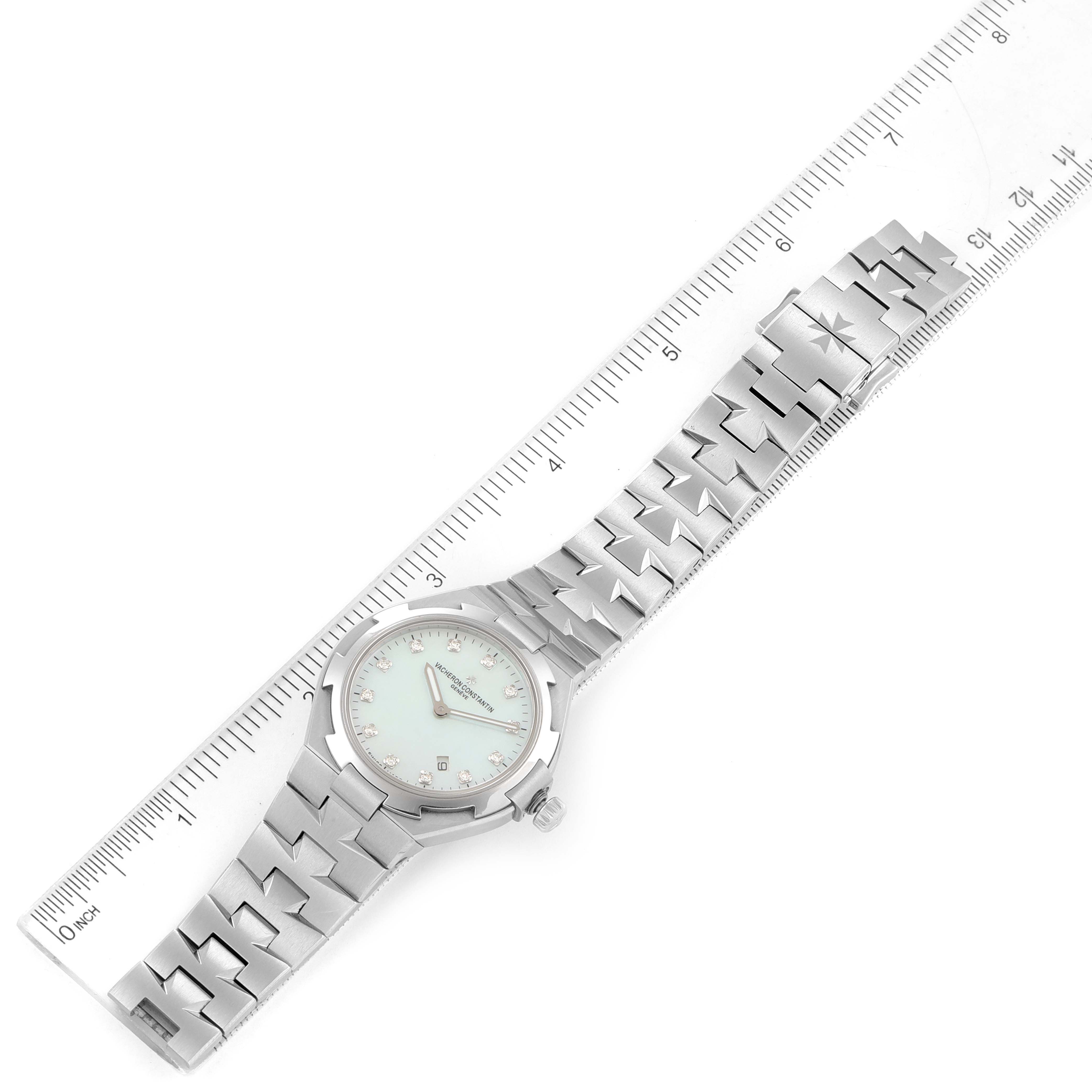 The image shows a top-down view of a Vacheron Constantin Overseas 25250/D01A-9092 Women's Stainless Steel Mother of Pearl Dial 25250/D01A-9092 Women's Stainless Steel Mother of Pearl Dial watch alongside a ruler for size comparison.