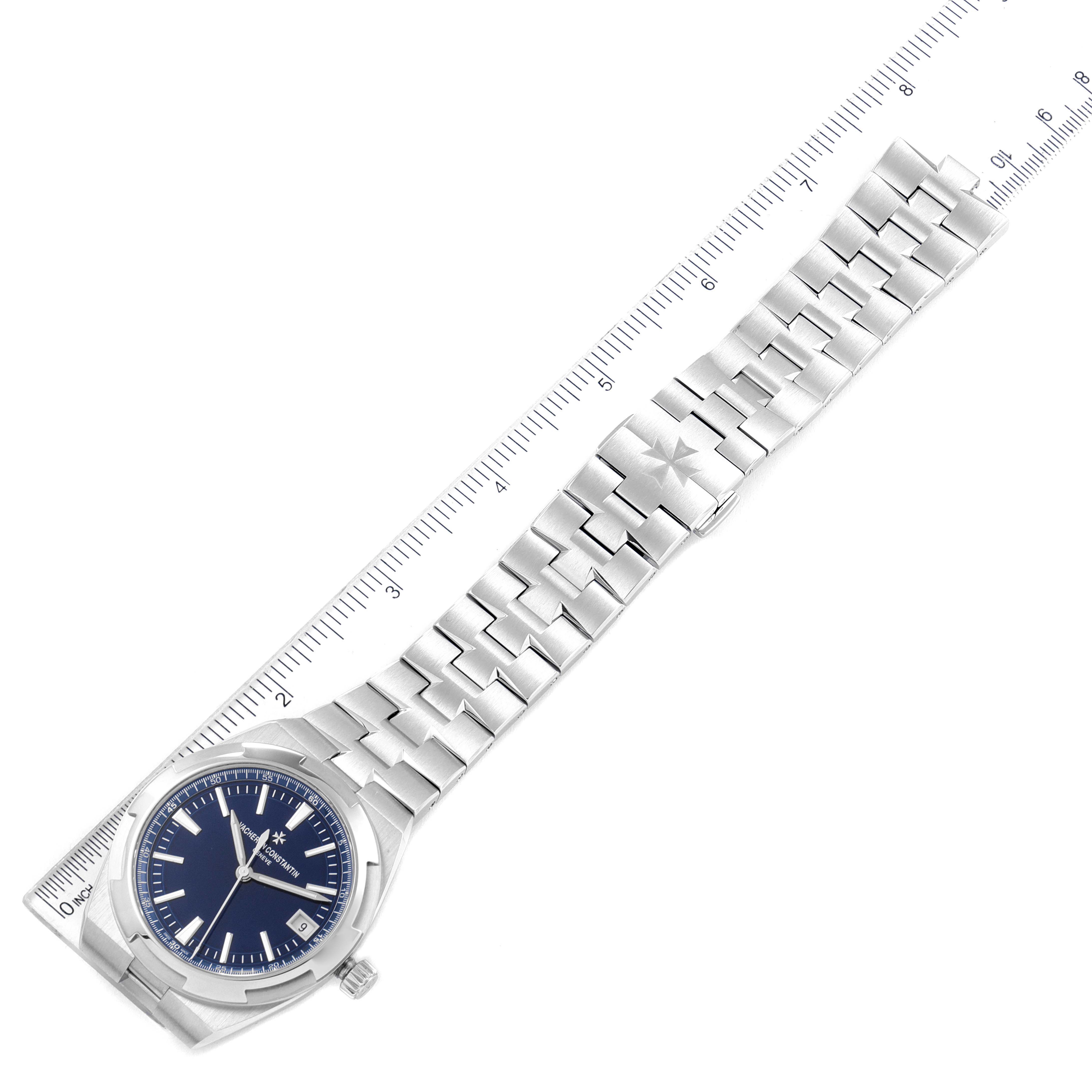 The image shows a Vacheron Constantin Overseas 4500V/110A-B128 Men's Stainless Steel Blue Dial 4500V/110A-B128 Men's Stainless Steel Blue Dial watch at a top-down angle, highlighting the blue dial, stainless steel case, and bracelet alongside a ruler.