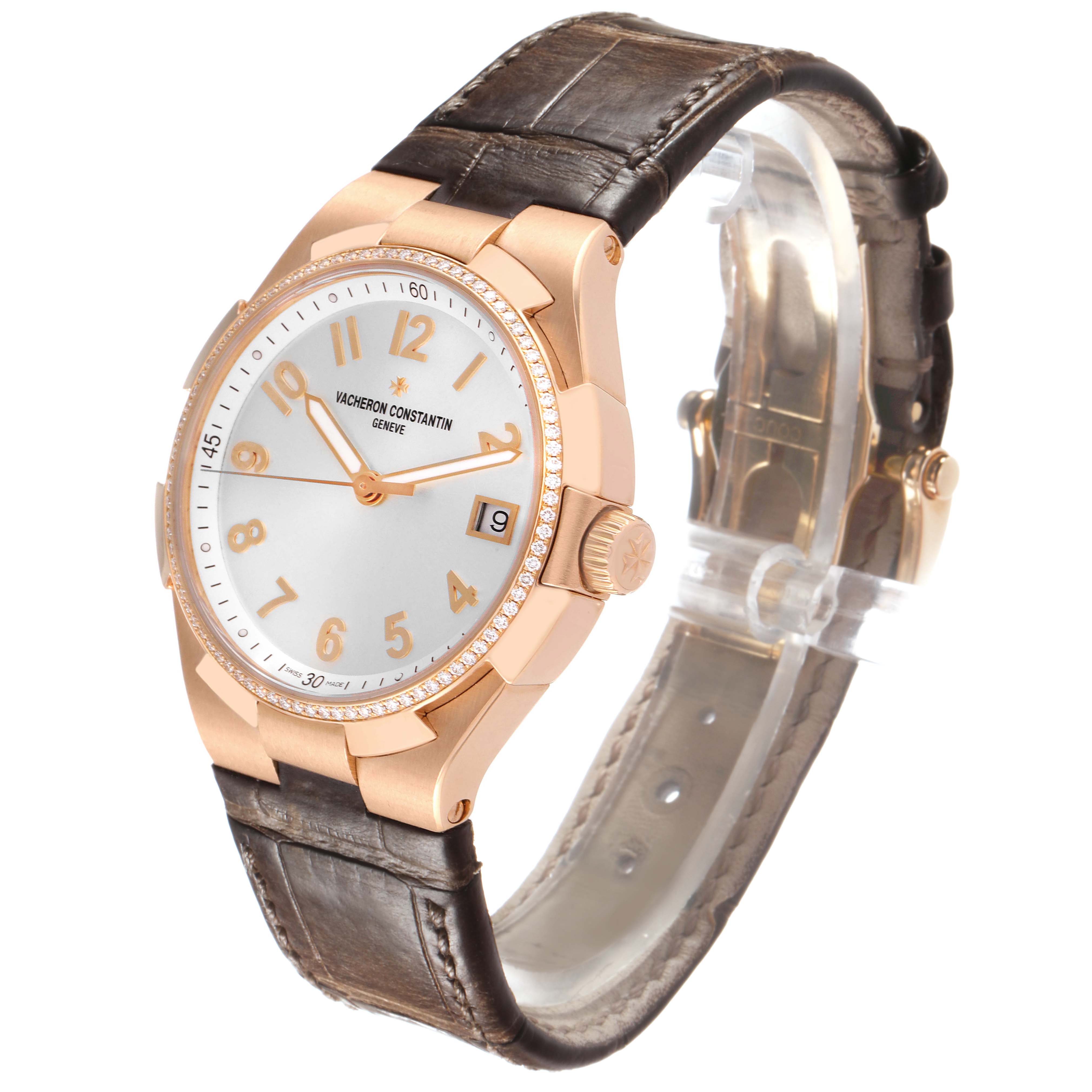 The Vacheron Constantin Overseas 47560/000R-9672 Women's Rose Gold Silver Dial watch is shown at an angled view, highlighting the dial, case, bezel, and part of the strap.