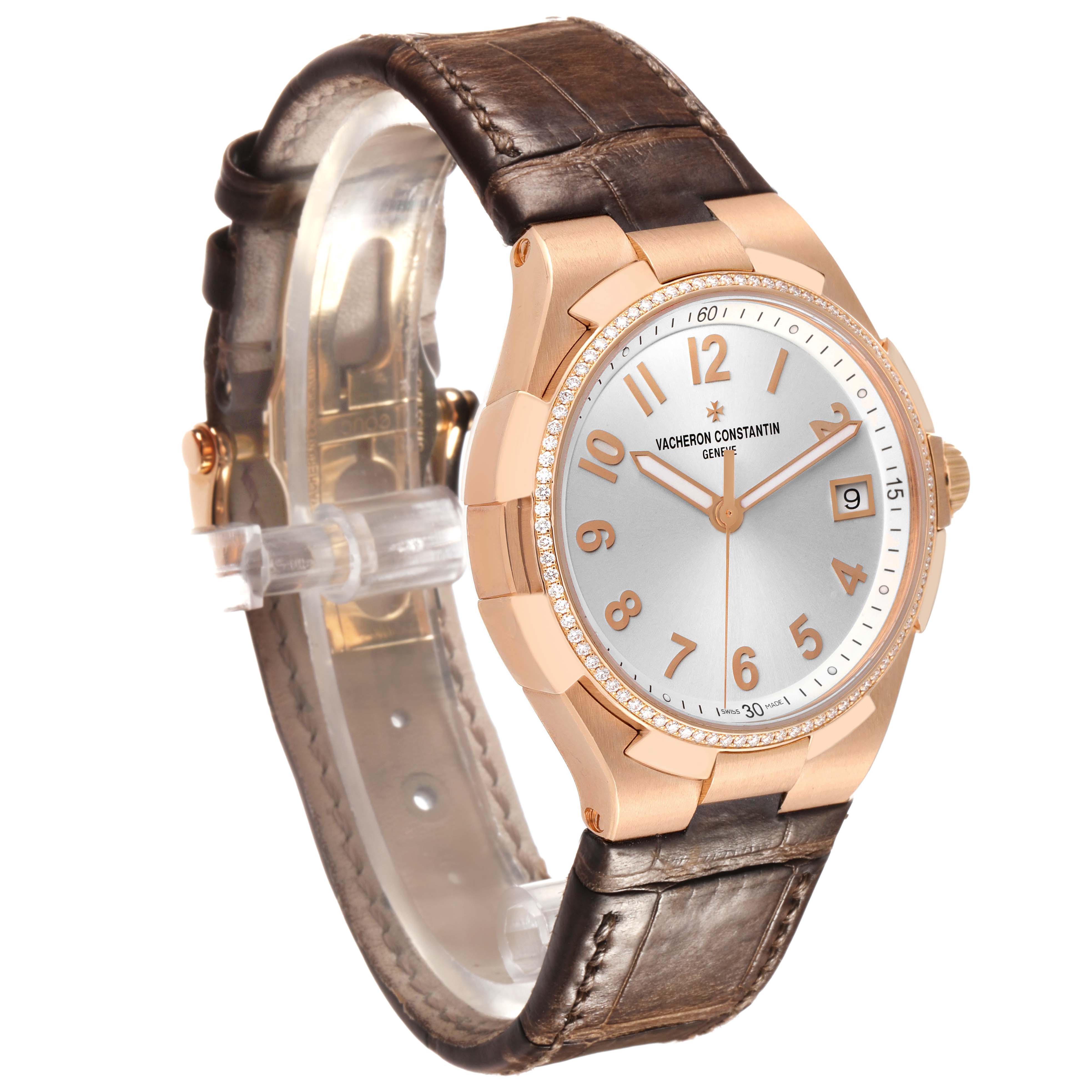 The Vacheron Constantin Overseas 47560/000R-9672 Women's Rose Gold Silver Dial watch is shown at a three-quarter angle, displaying its dial, case, and leather strap.