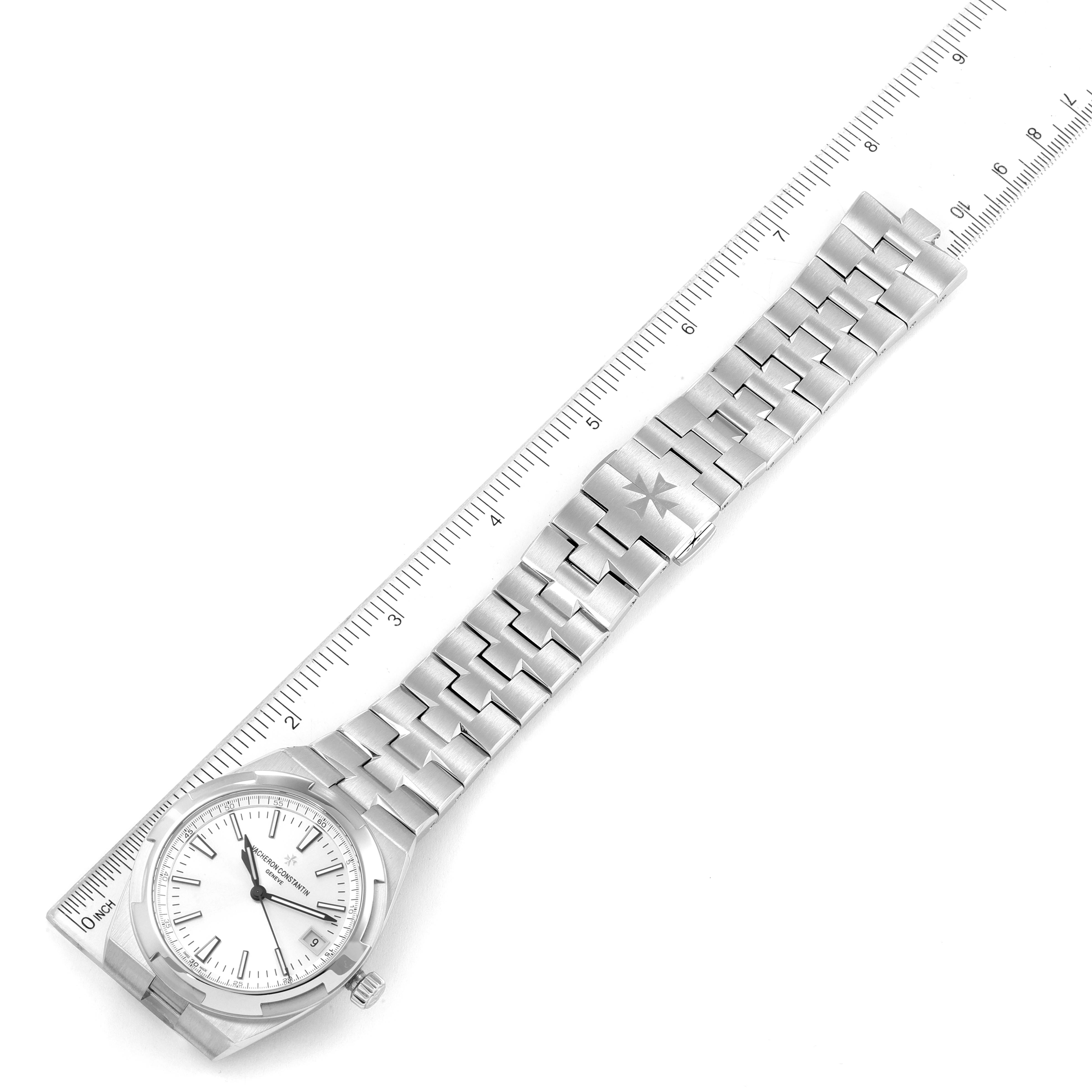 The Vacheron Constantin Overseas 4500V/110A-B126 Men's Stainless Steel Silver Dial 4500V/110A-B126 Men's Stainless Steel Silver Dial watch is shown from a top-down angle, displaying the face and bracelet next to a ruler.