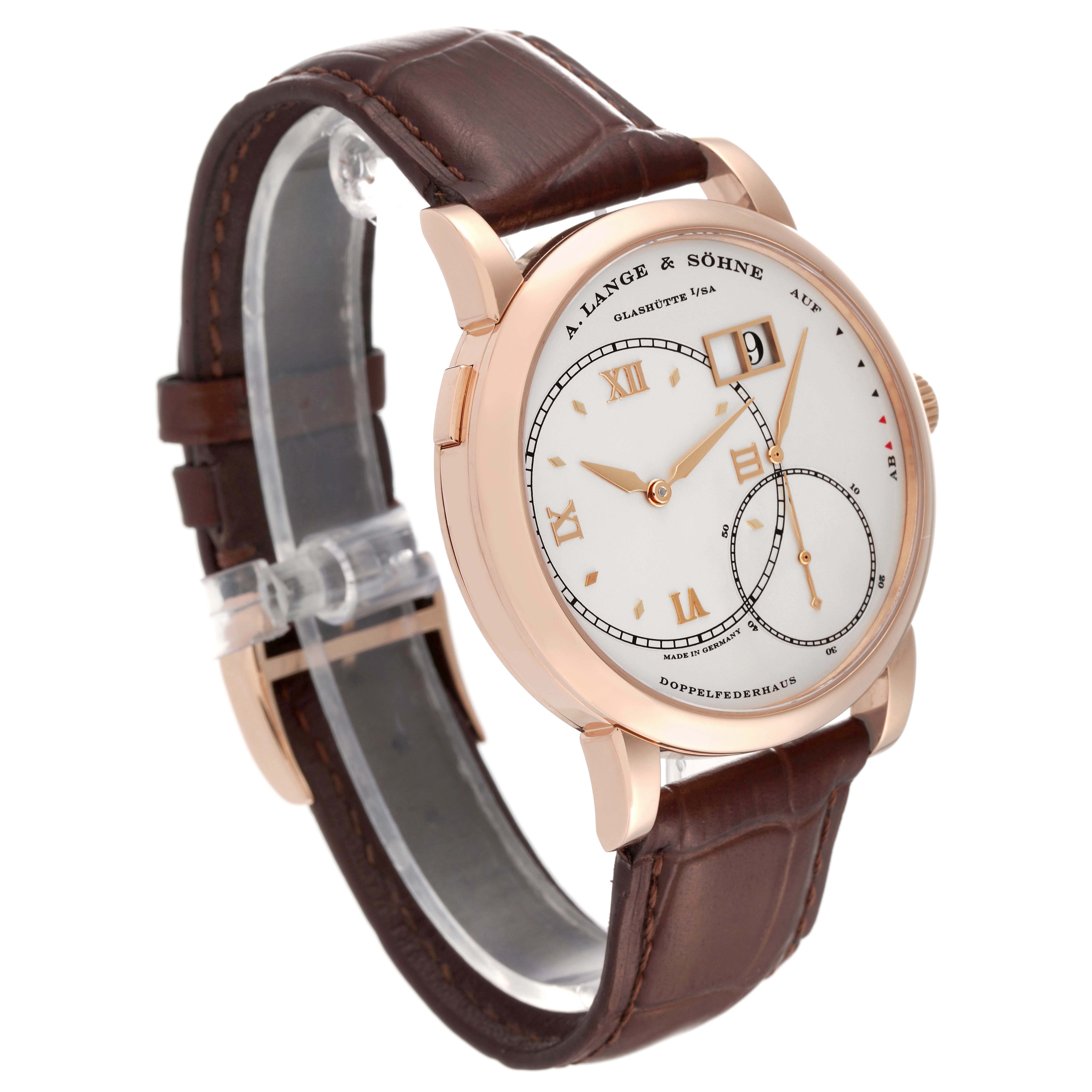 The image shows a side angle of the A. Lange & Sohne Lange 1 115.032 Men's Rose Gold Silver Dial watch with a white dial and a brown leather strap.