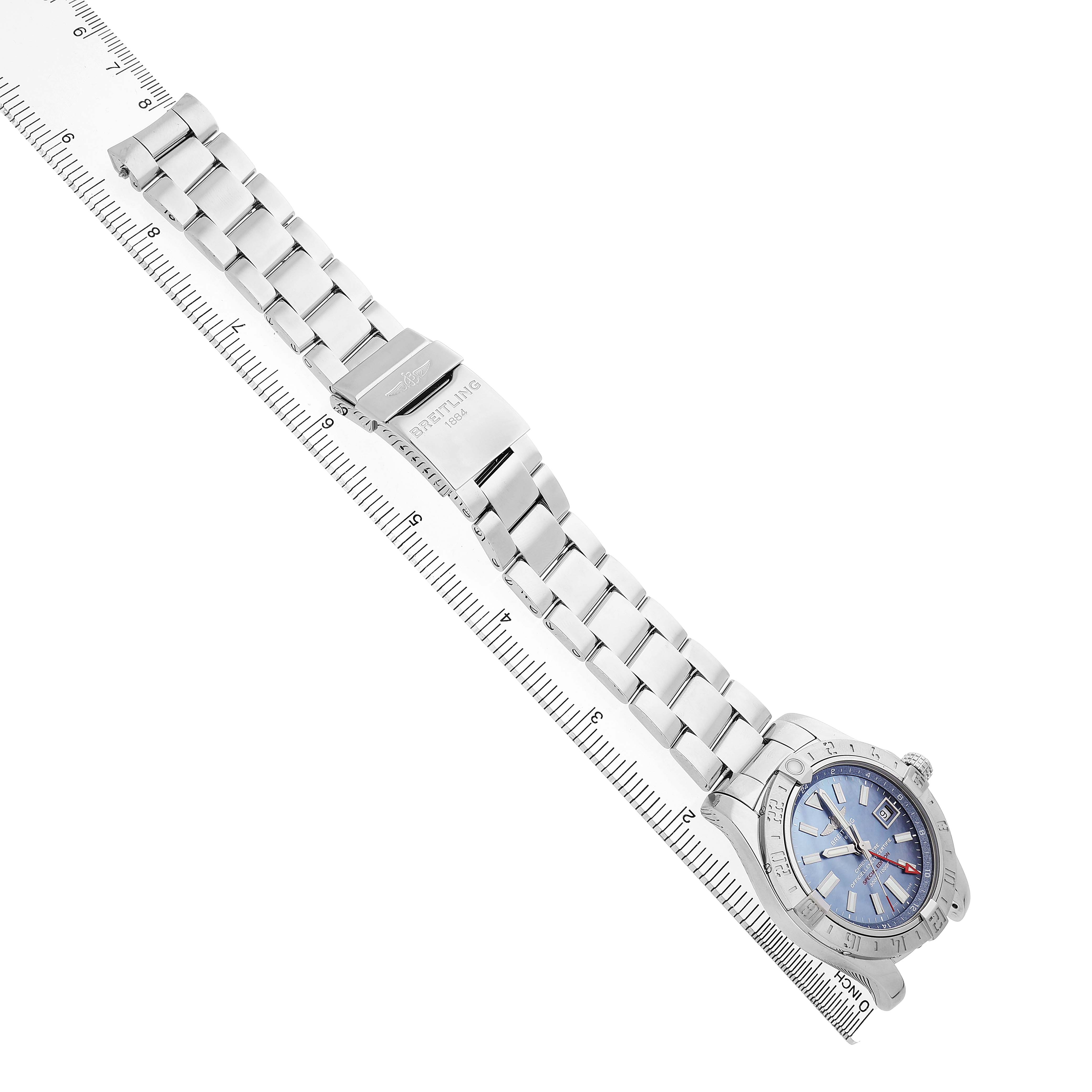 This image shows a Breitling Avenger A3239011/C930 Men's Stainless Steel Blue Dial watch from a diagonal angle, highlighting the bracelet and clasp alongside a ruler.