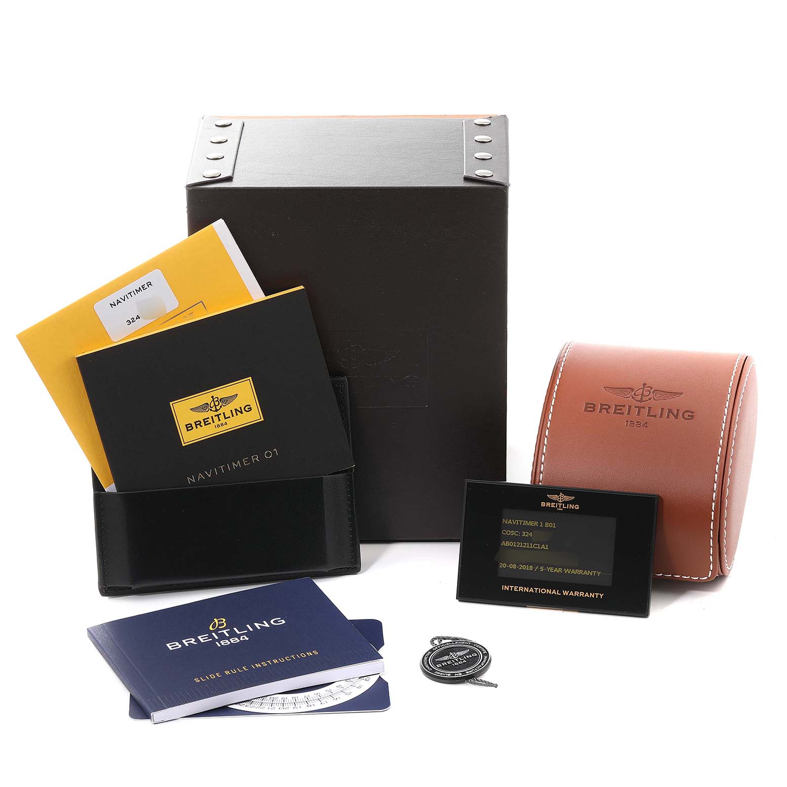 The image shows accessories for a Breitling Navitimer AB0121 Men
s Stainless Steel Blue Dial AB0121 Men
s Stainless Steel Blue Dial, including manuals, boxes, a warranty card, and a leather case.