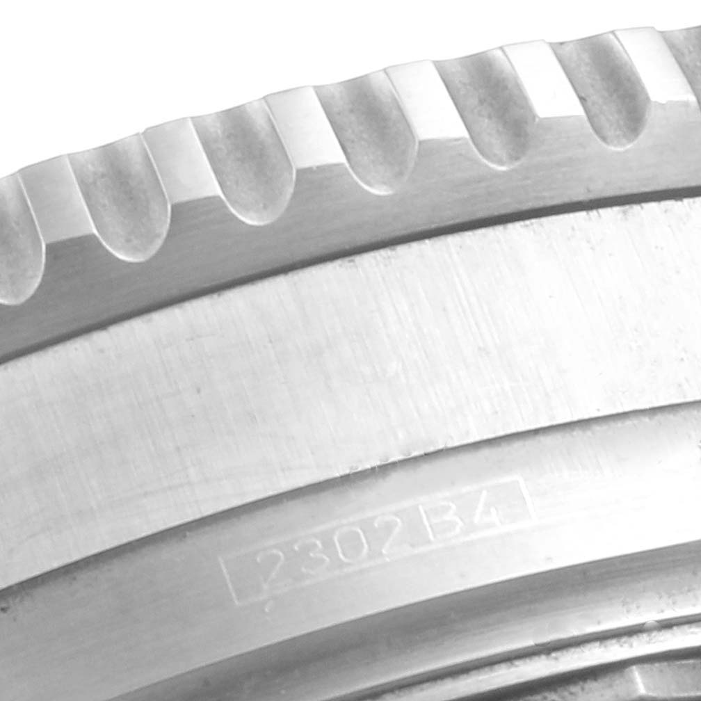 The image shows a close-up of the serrated bezel and part of the engraved case back for the Breitling Navitimer A41322 Men's Stainless Steel Silver Dial A41322 Men's Stainless Steel Silver Dial watch.