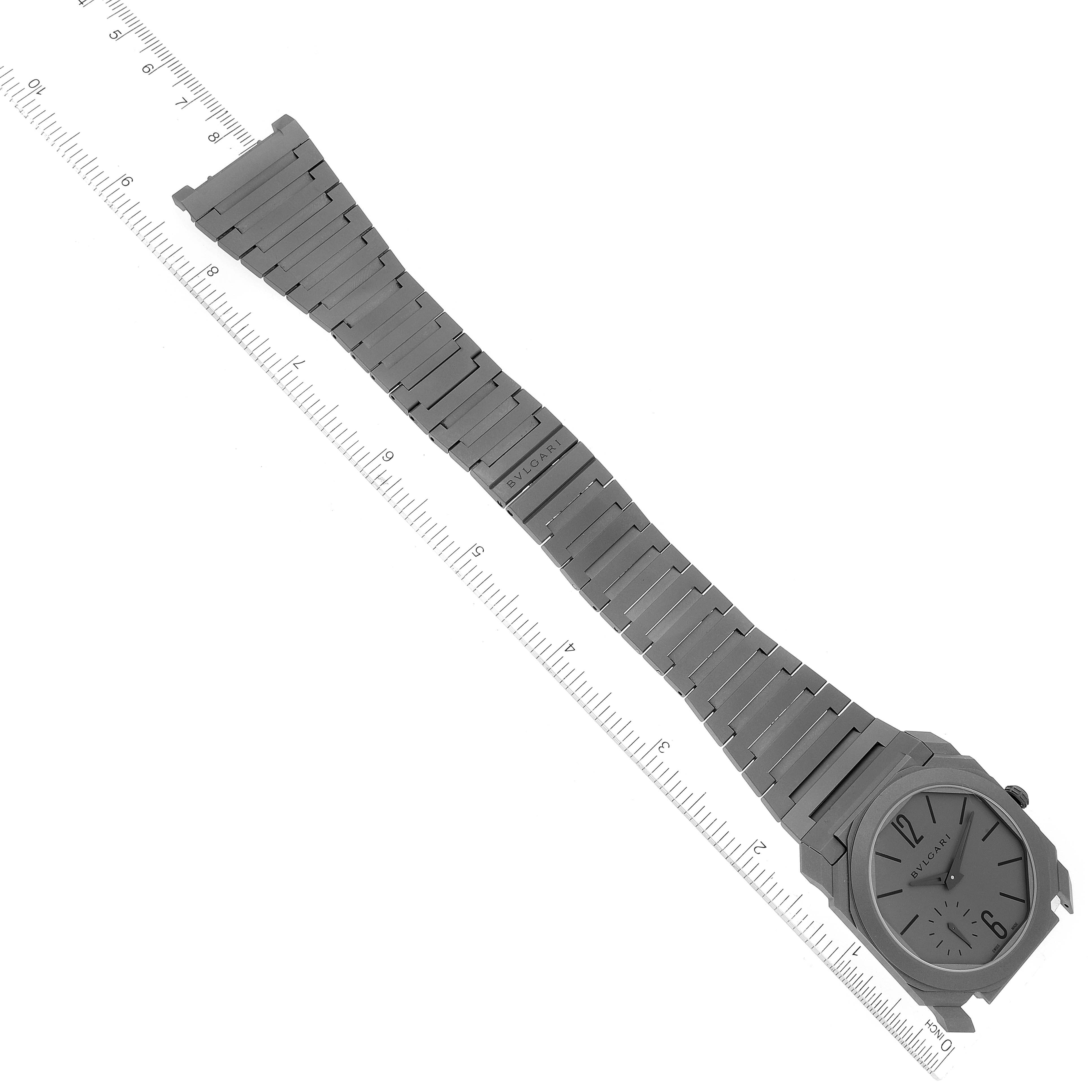 The image shows a top-down view of a Bvlgari Octo 102713 Men's Titanium Grey Dial 102713 Men's Titanium Grey Dial watch and its fully extended metal bracelet.