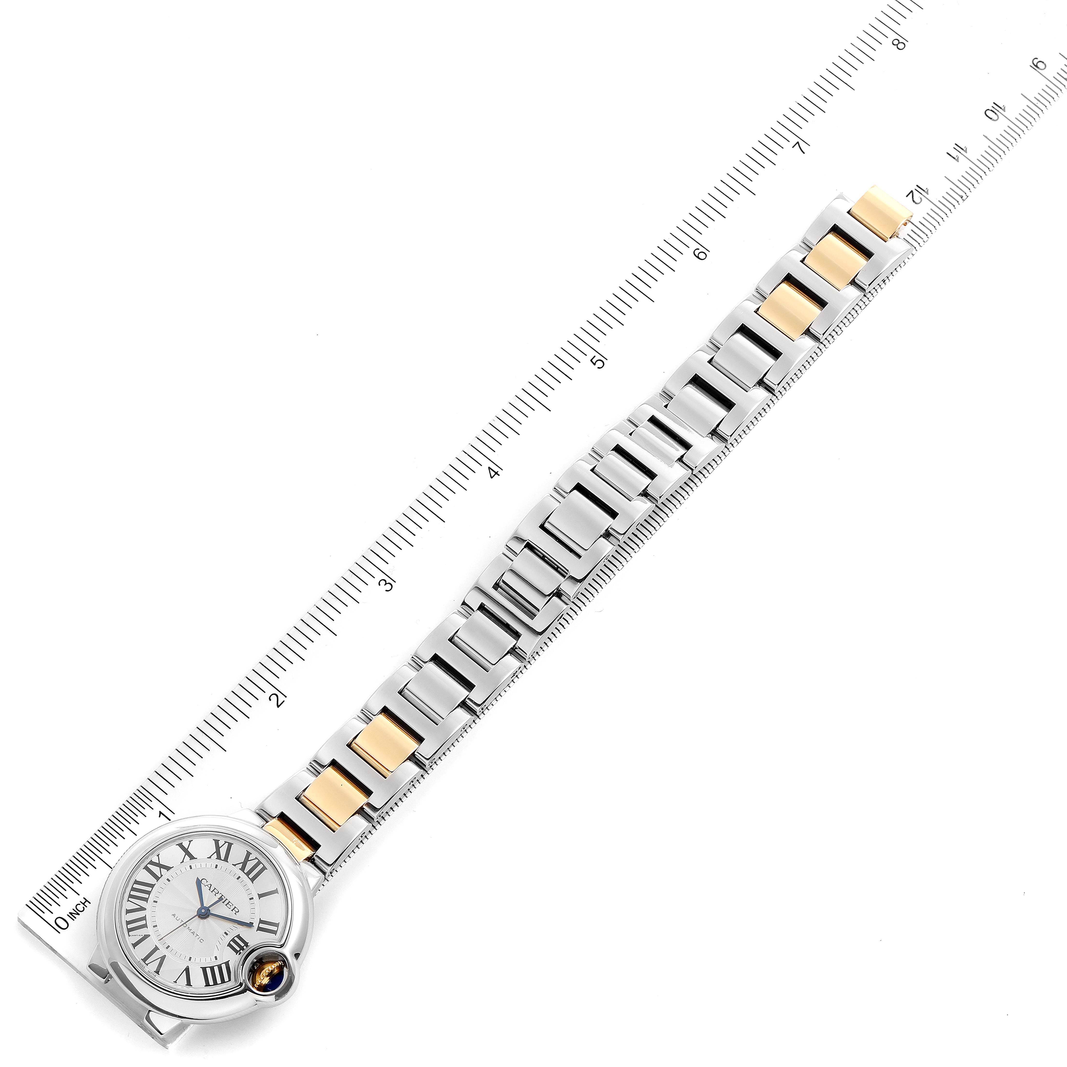 The image shows a top-down view of a Ballon Bleu watch by Cartier with a ruler alongside for measurement.
