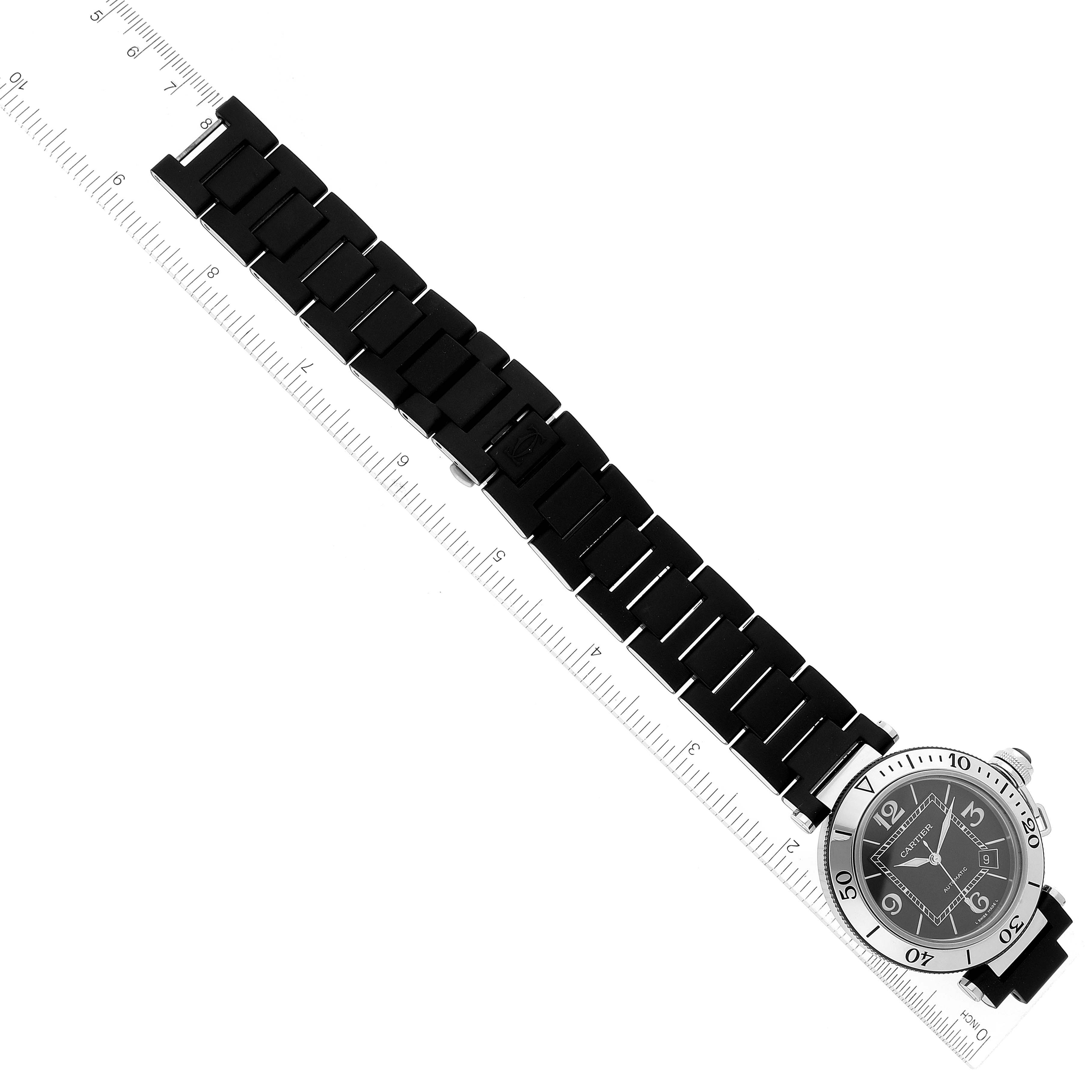 The Cartier Pasha W31077U2 Men
s Stainless Steel Black Dial W31077U2 Men
s Stainless Steel Black Dial watch is shown from an overhead angle with a full view of the face, bezel, and band against a ruler for sizing.