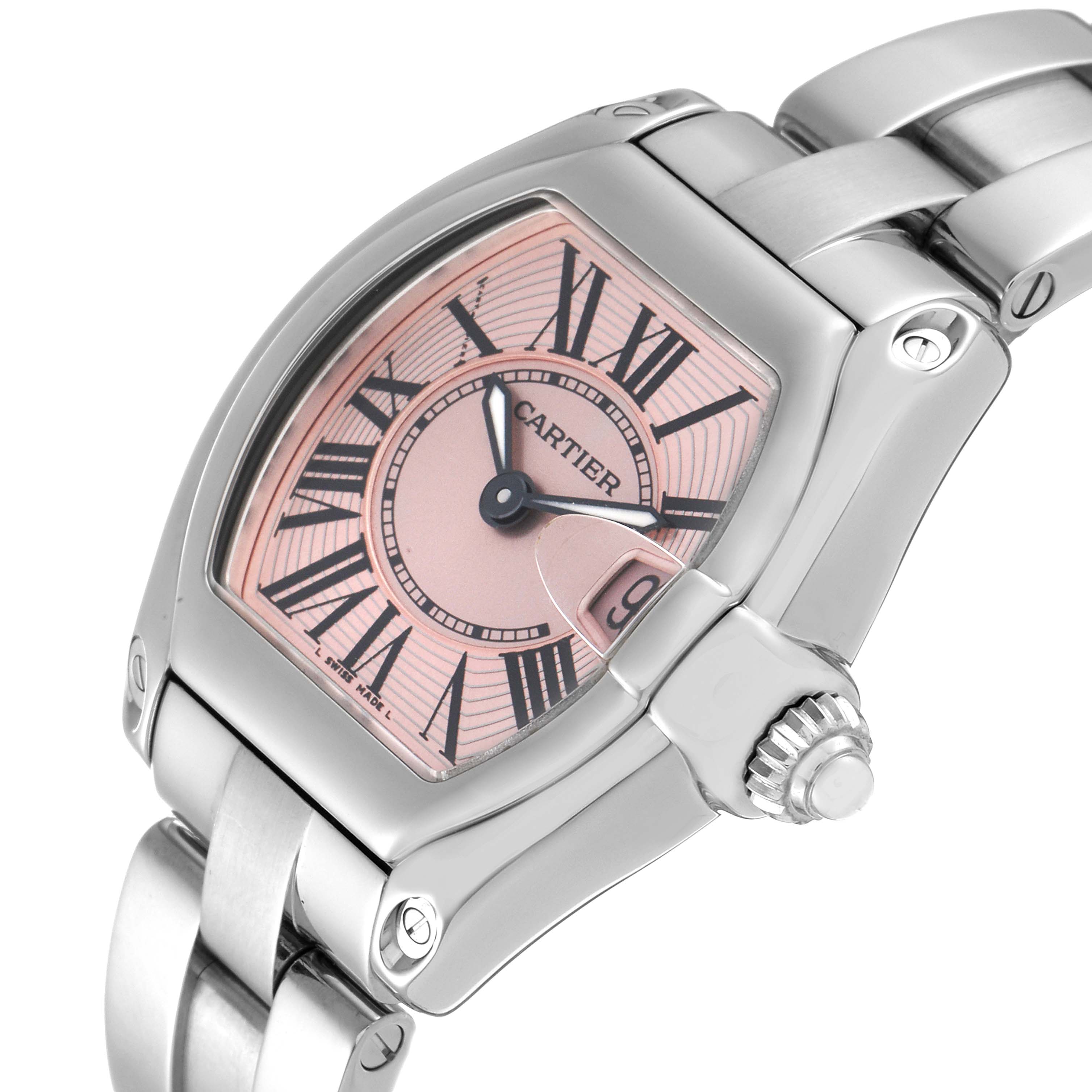 The image shows a close-up angle of a Cartier Roadster W62017V3 Women's Stainless Steel Pink Dial W62017V3 Women's Stainless Steel Pink Dial watch displaying its face, bezel, crown, and part of the bracelet.