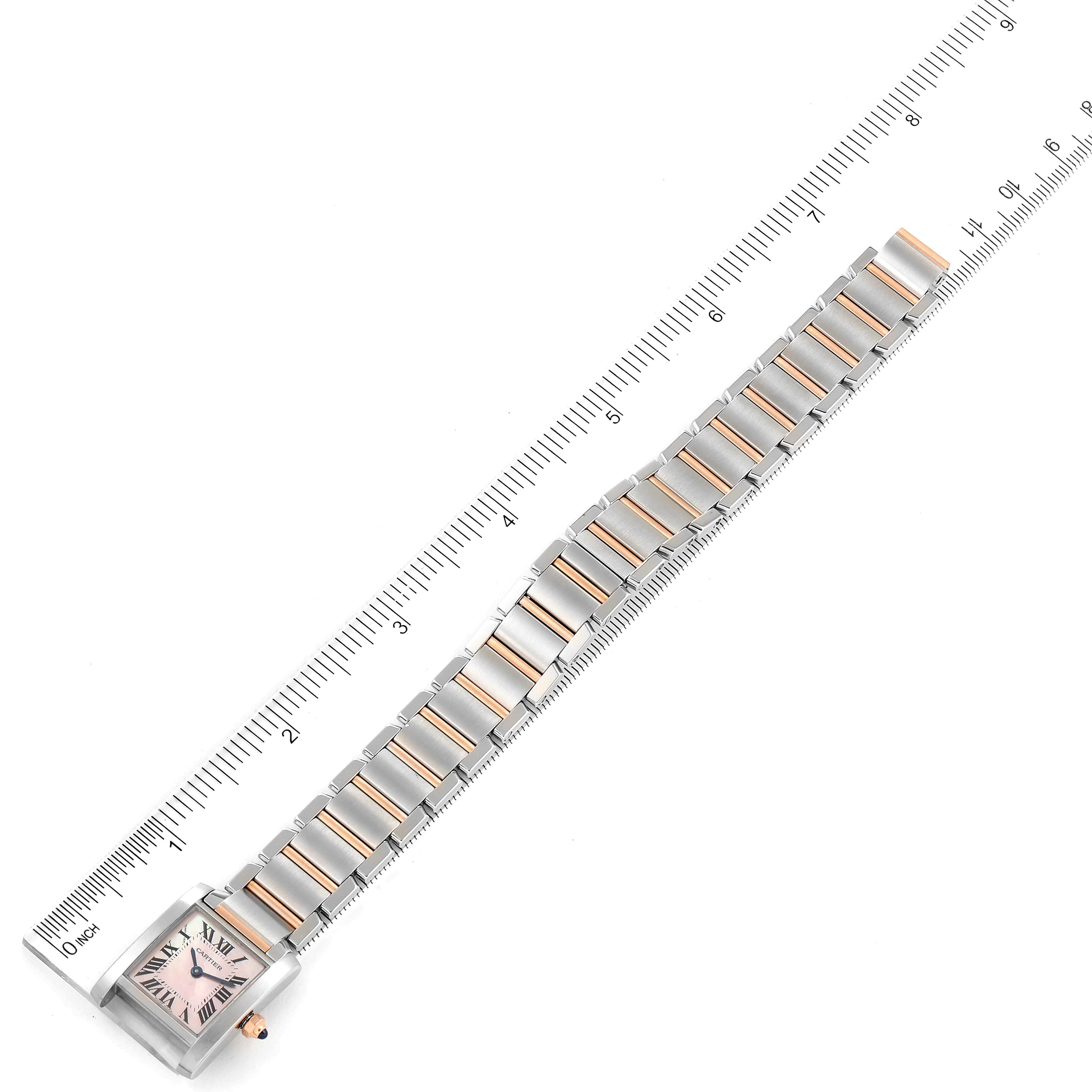 The image shows a Cartier Tank Francaise W51027Q4 Women
s Stainless Steel Mother of Pearl Dial W51027Q4 Women
s Stainless Steel Mother of Pearl Dial watch fully extended, aligned with a ruler, displaying the face and entire band.
