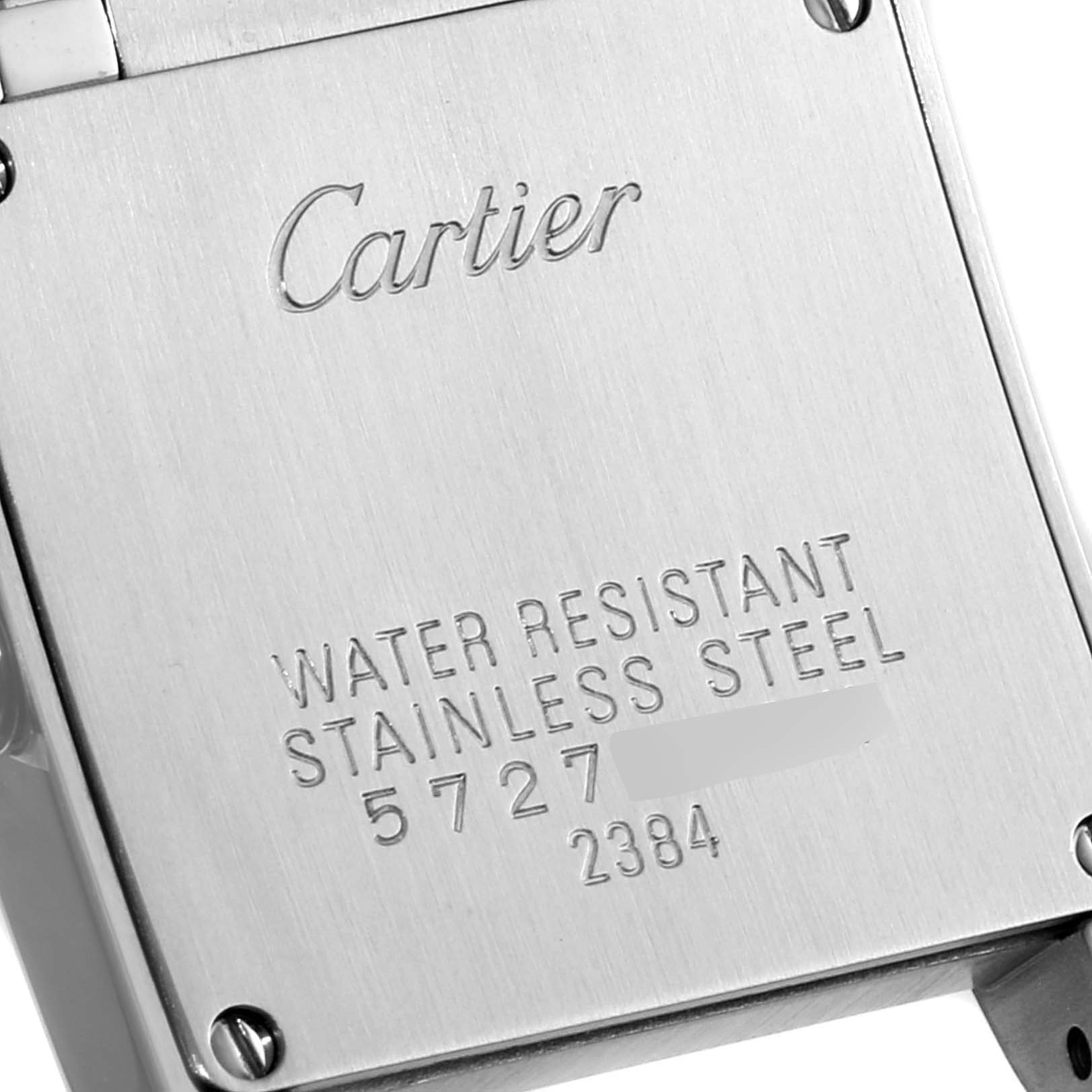 The image shows the back case of a Cartier Tank Francaise W51027Q4 Women
s Stainless Steel Mother of Pearl Dial W51027Q4 Women
s Stainless Steel Mother of Pearl Dial watch, highlighting the engraved brand name and details.