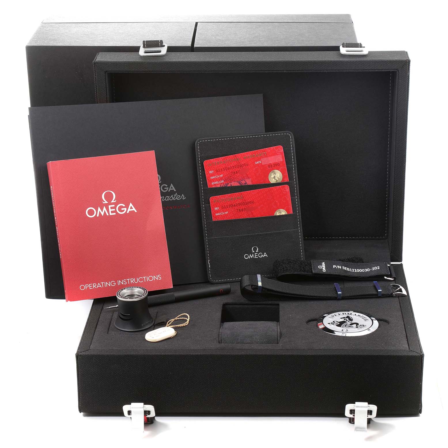 This image shows the packaging and accessories of an Omega Speedmaster 311.30.42.30.01.006 Men
s Stainless Steel Black Dial 311.30.42.30.01.006 Men
s Stainless Steel Black Dial watch, including booklets, cards, and additional tools.