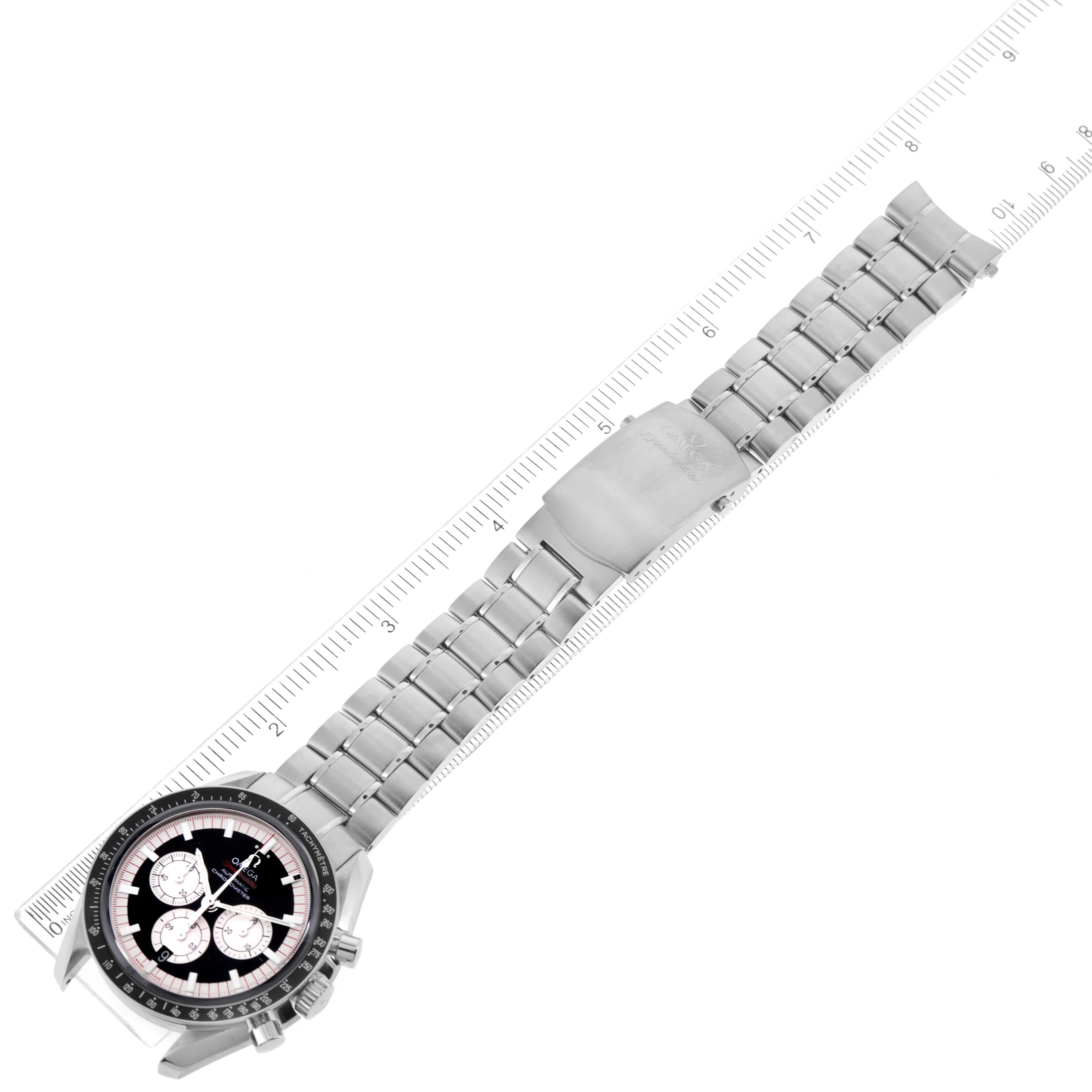 The image shows an angled view of an Omega Speedmaster 3507.51.00 Men
s Stainless Steel Black Dial 3507.51.00 Men
s Stainless Steel Black Dial watch, featuring its face, case, and full metal bracelet laid over a ruler.