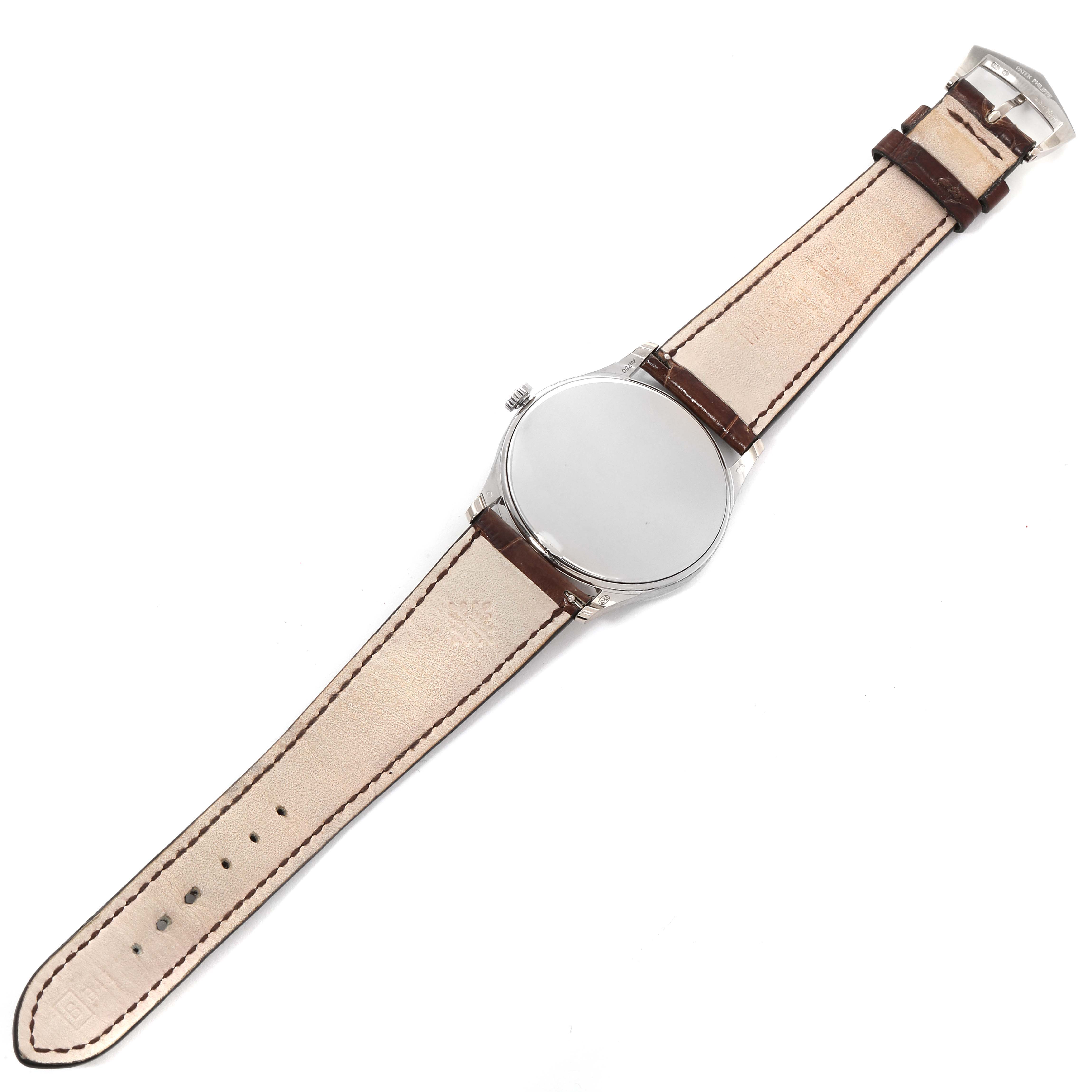 This image shows a top-down view of the Patek Philippe Calatrava 5196G Men
s White Gold Silver Dial 5196G Men
s White Gold Silver Dial watch displaying its case, crown, and leather strap.