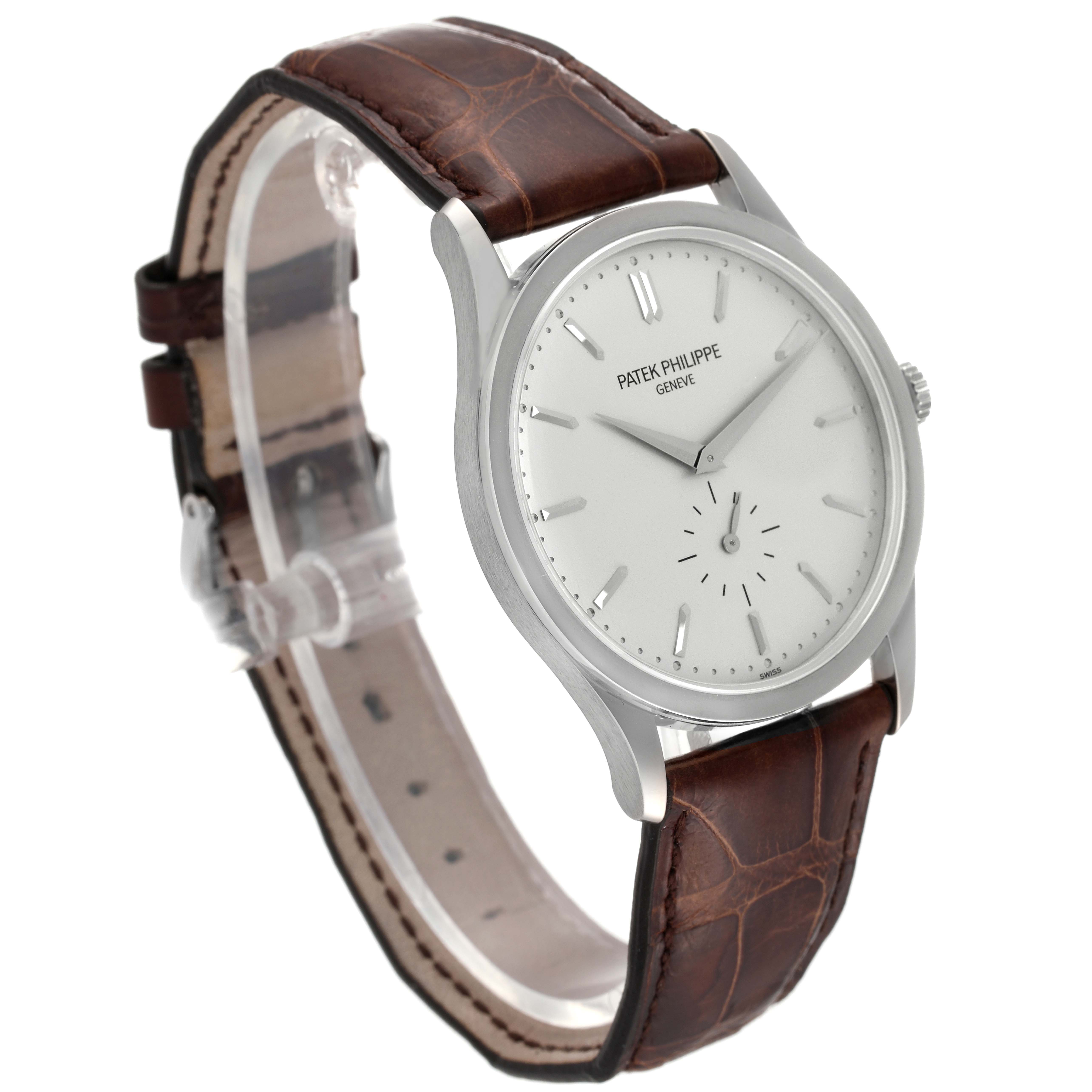 The image shows a Patek Philippe Calatrava 5196G Men
s White Gold Silver Dial 5196G Men
s White Gold Silver Dial watch at a slight angle, featuring its white dial and brown leather strap.