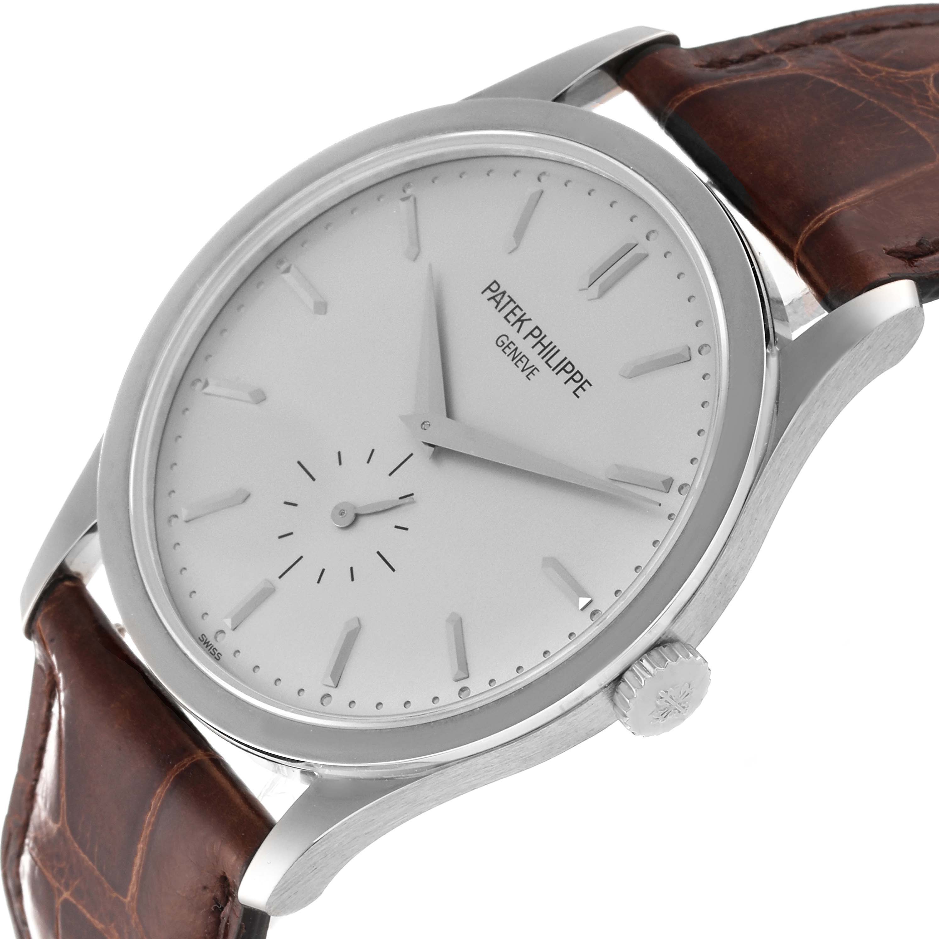 The image shows a side angle of the Patek Philippe Calatrava 5196G Men
s White Gold Silver Dial 5196G Men
s White Gold Silver Dial watch, highlighting the dial, crown, and leather strap.